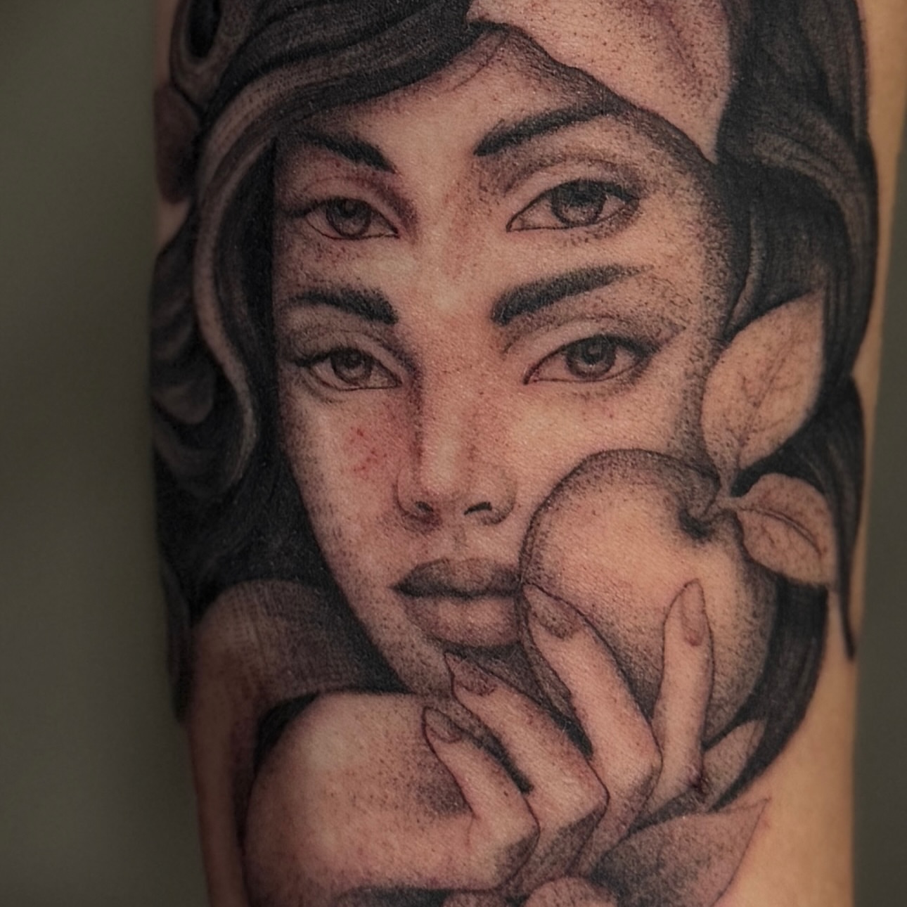 Woman holding apple realism tattoo on the forearm by Paul Jack II ⚜️ Tattoo Artist ⚜️Atlanta