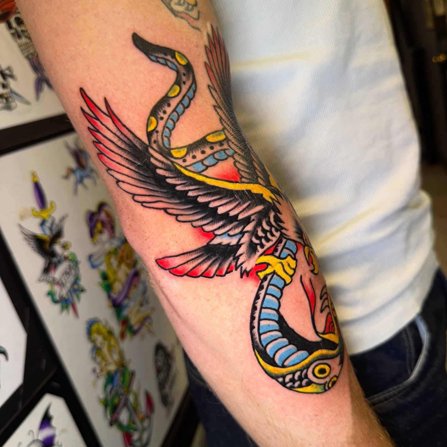 Winged snake American traditional tattoo on the forearm by Mike Dunn