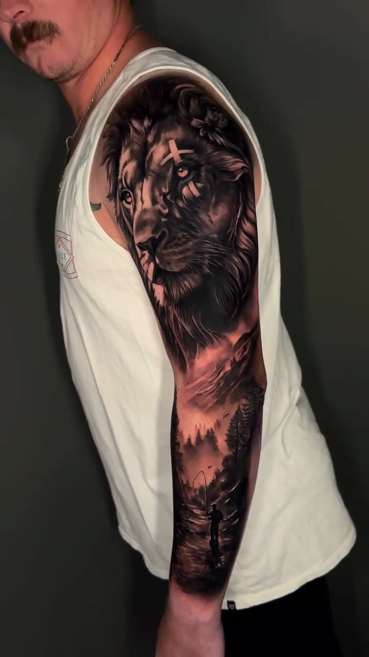Lion and forest landscape realism tattoo by Dakota Case