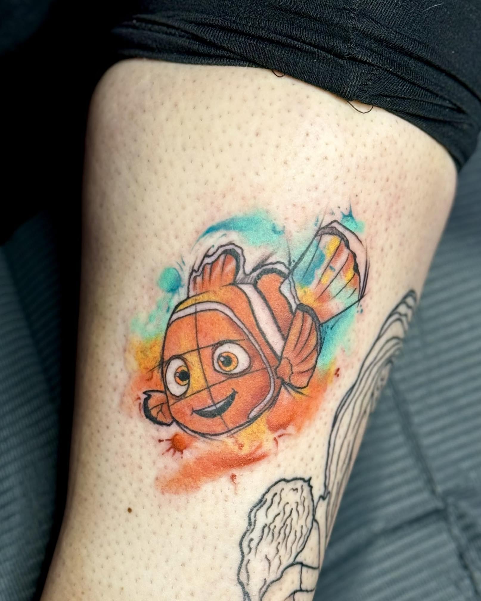 Clownfish watercolor tattoo on the thigh by Murbee