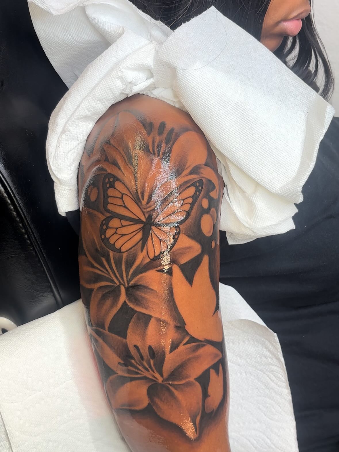 Monarch butterfly and lilies realism tattoo on the forearm by FleeDott 🇨🇴