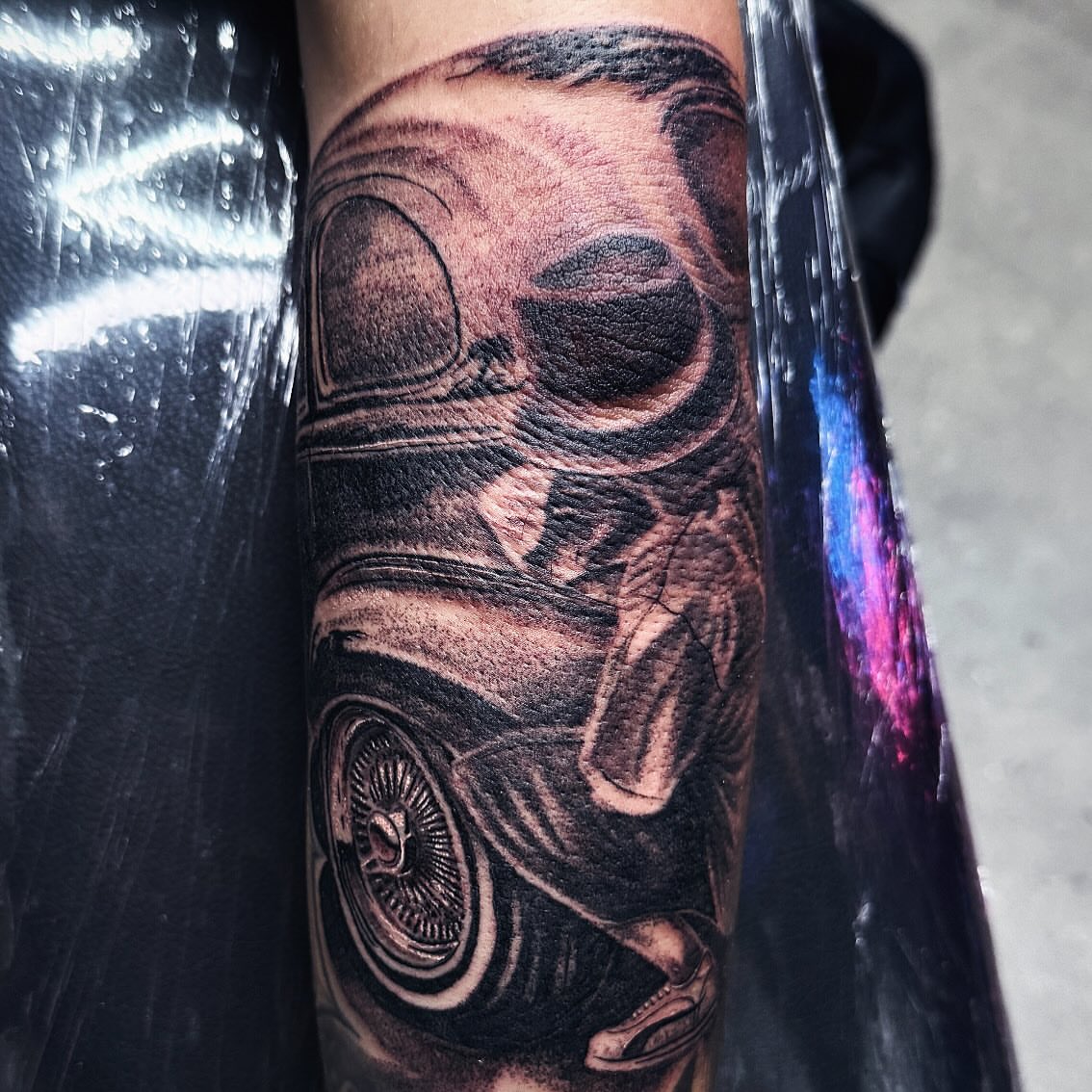 Car realism tattoo on the forearm by Joey Moreno