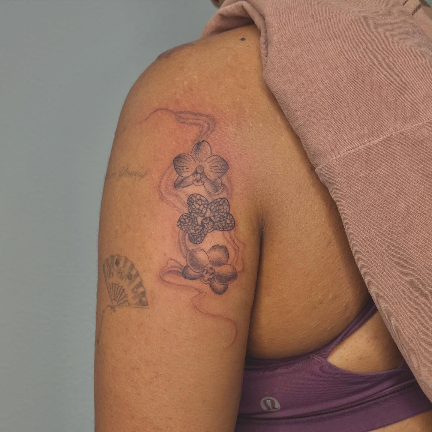 Orchids black and grey tattoo on the shoulder by Las Vegas Tattoo Artist