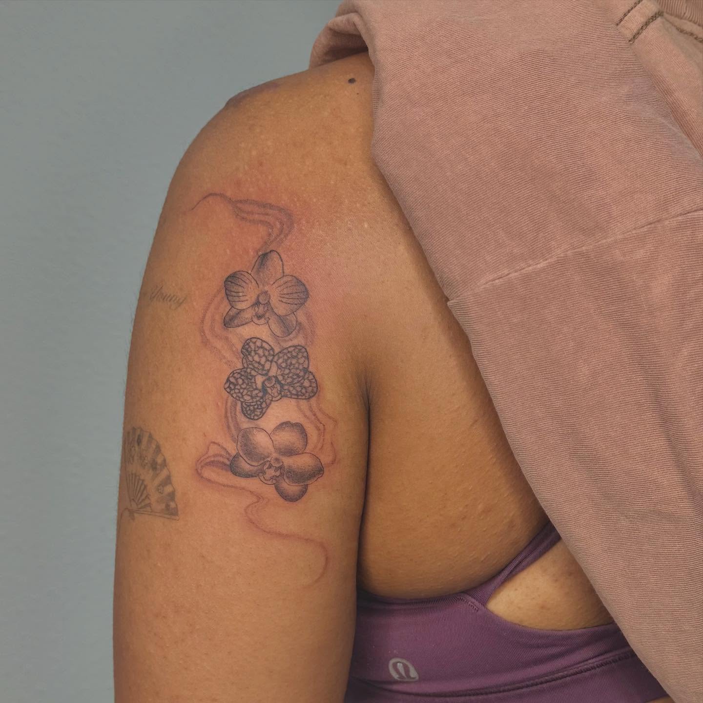 Orchids black and grey tattoo on the shoulder by Las Vegas Tattoo Artist
