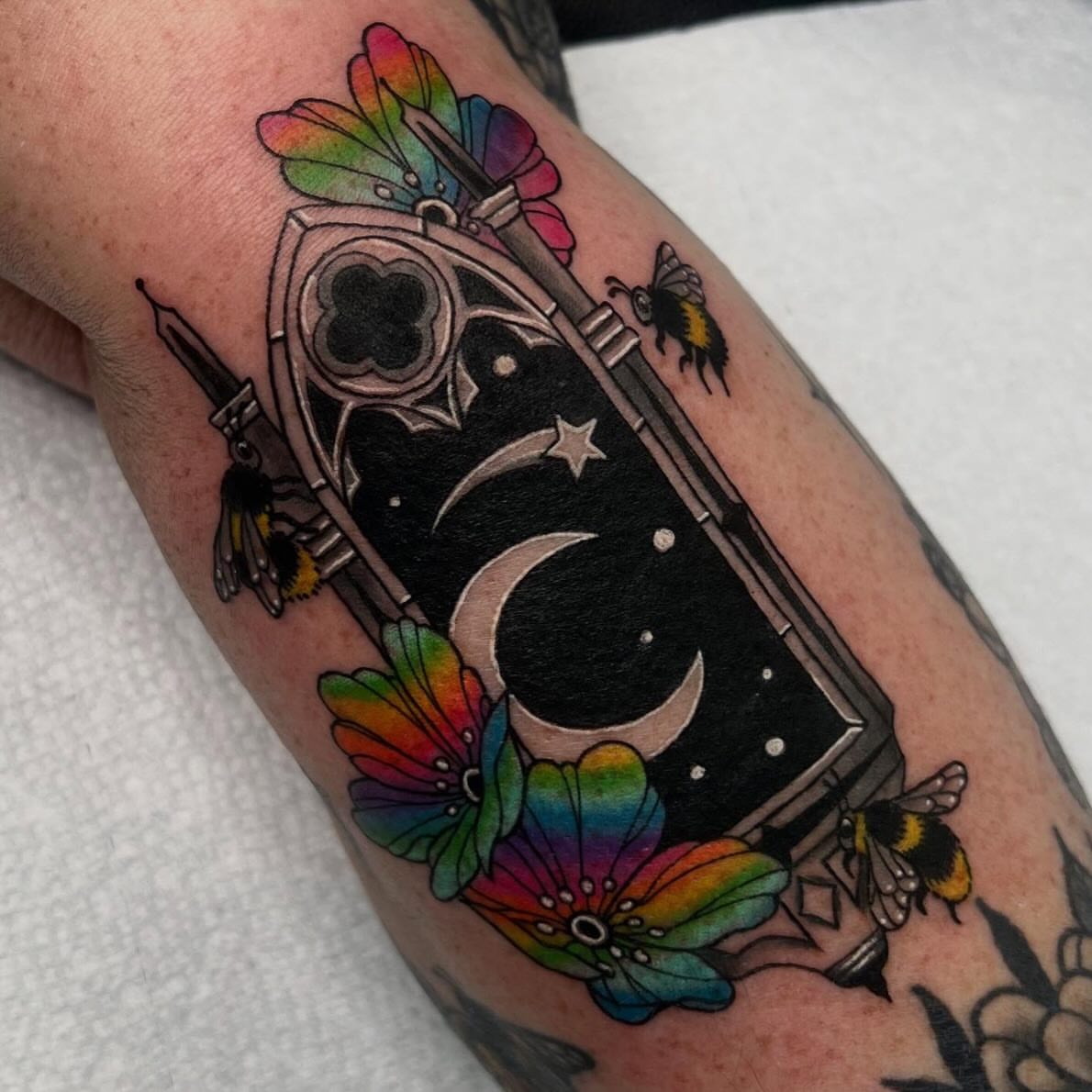 Astronaut helmet and celestial elements American traditional tattoo on the forearm by Kahlan ⍟