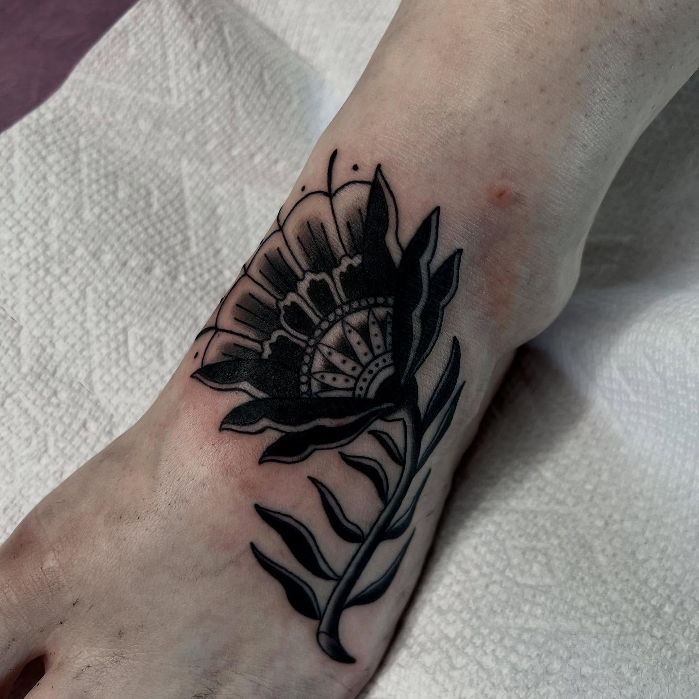 Flower black and grey tattoo on the forearm by Kahlan ⍟