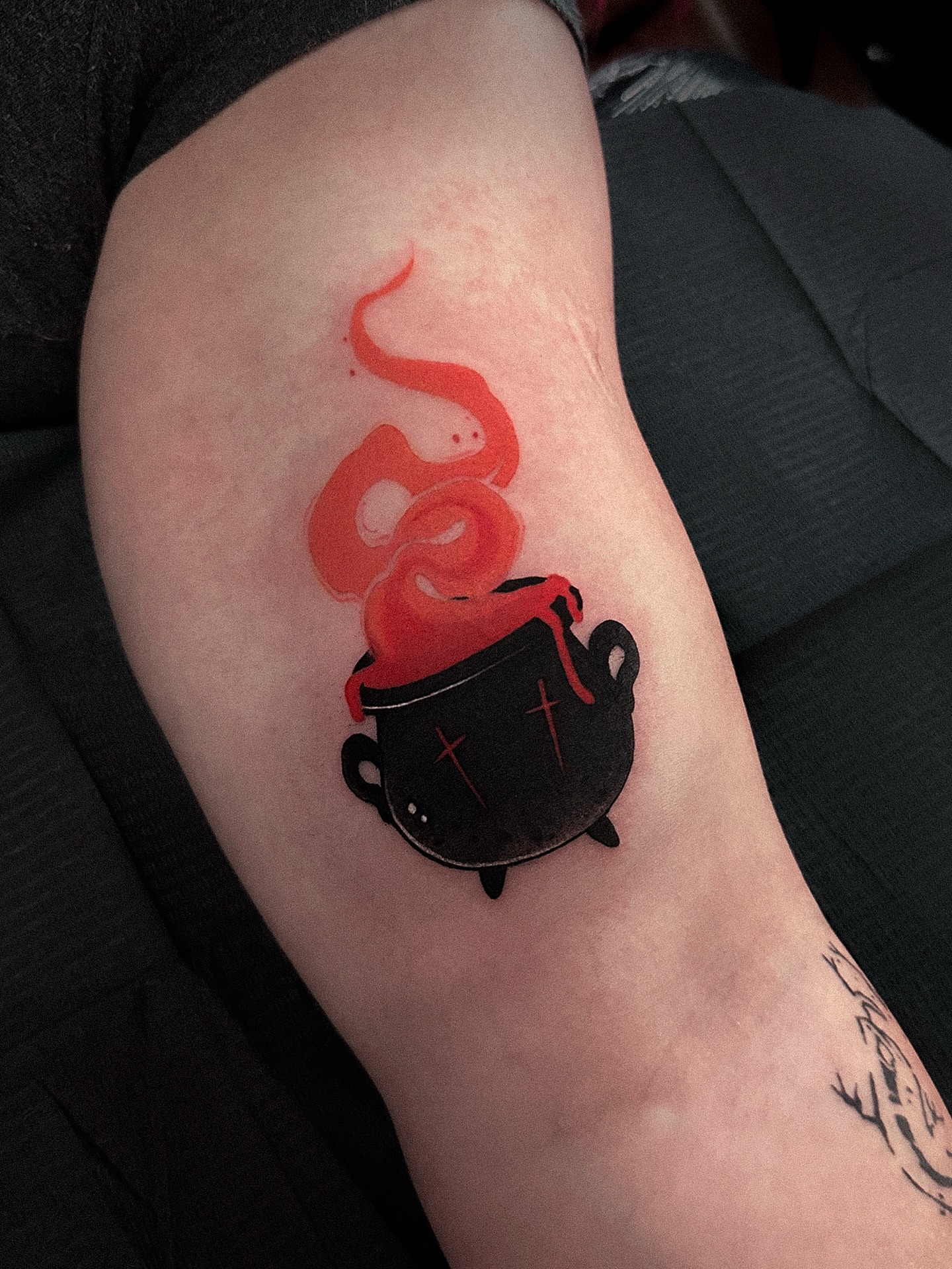 Cauldron with boiling potion watercolor tattoo on the forearm by Tattoo Artist 👩🏻‍🎨 ATX