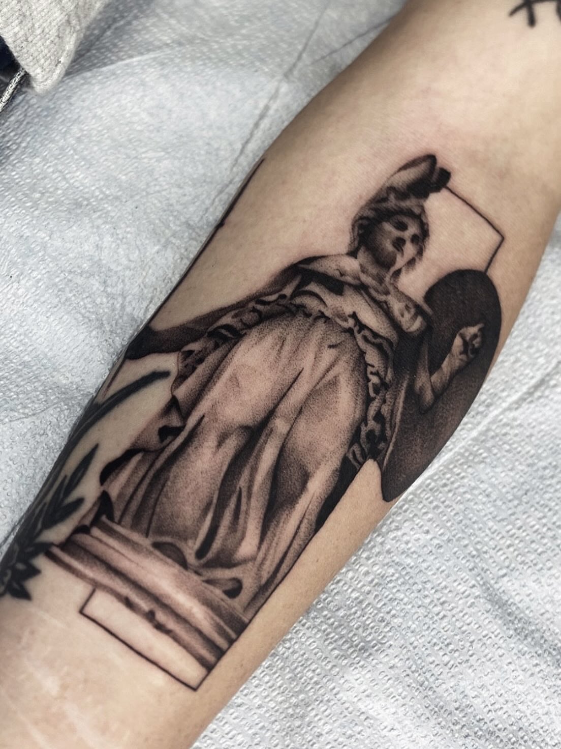 Statue of woman black and grey tattoo on the forearm by Cody Mason