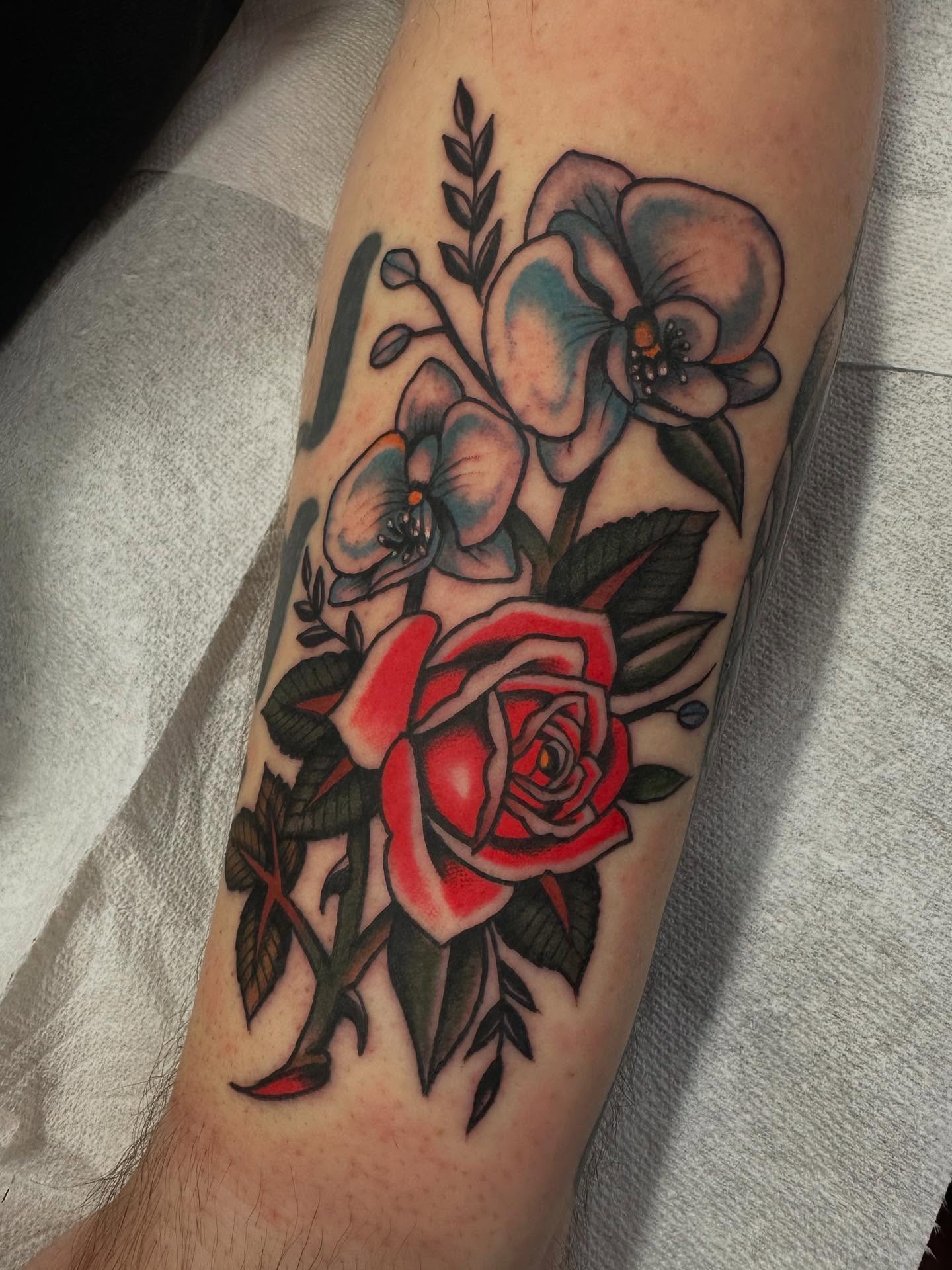 Floral bouquet American traditional tattoo on the forearm by David Evans