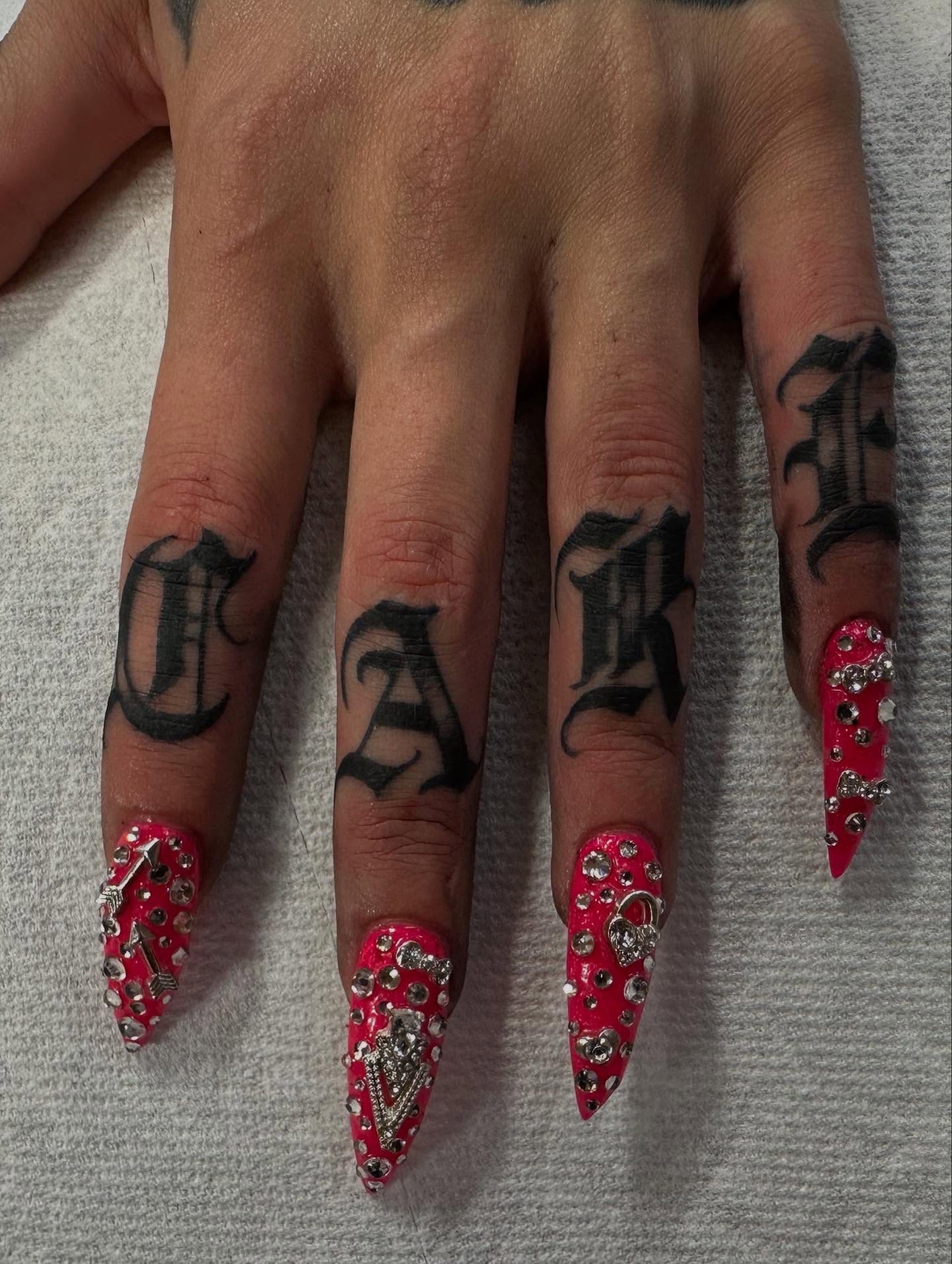 Studded nails lettering script tattoo on the hand by David Evans