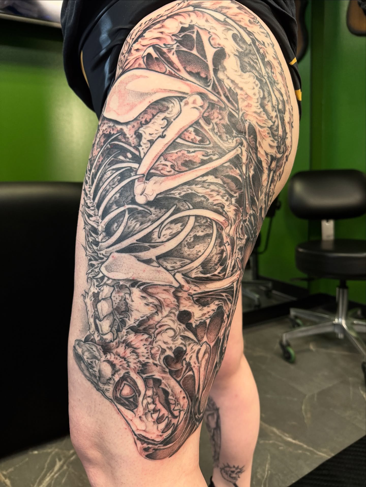 Skull and skeleton realism tattoo on the thigh by Joe Hall