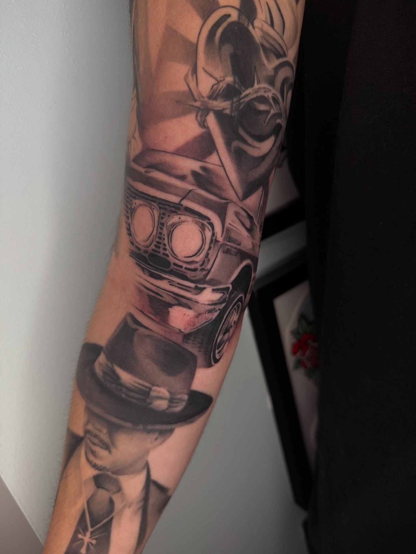 Car and man realism tattoo on the forearm by Angel, Salt Lake City, Utah