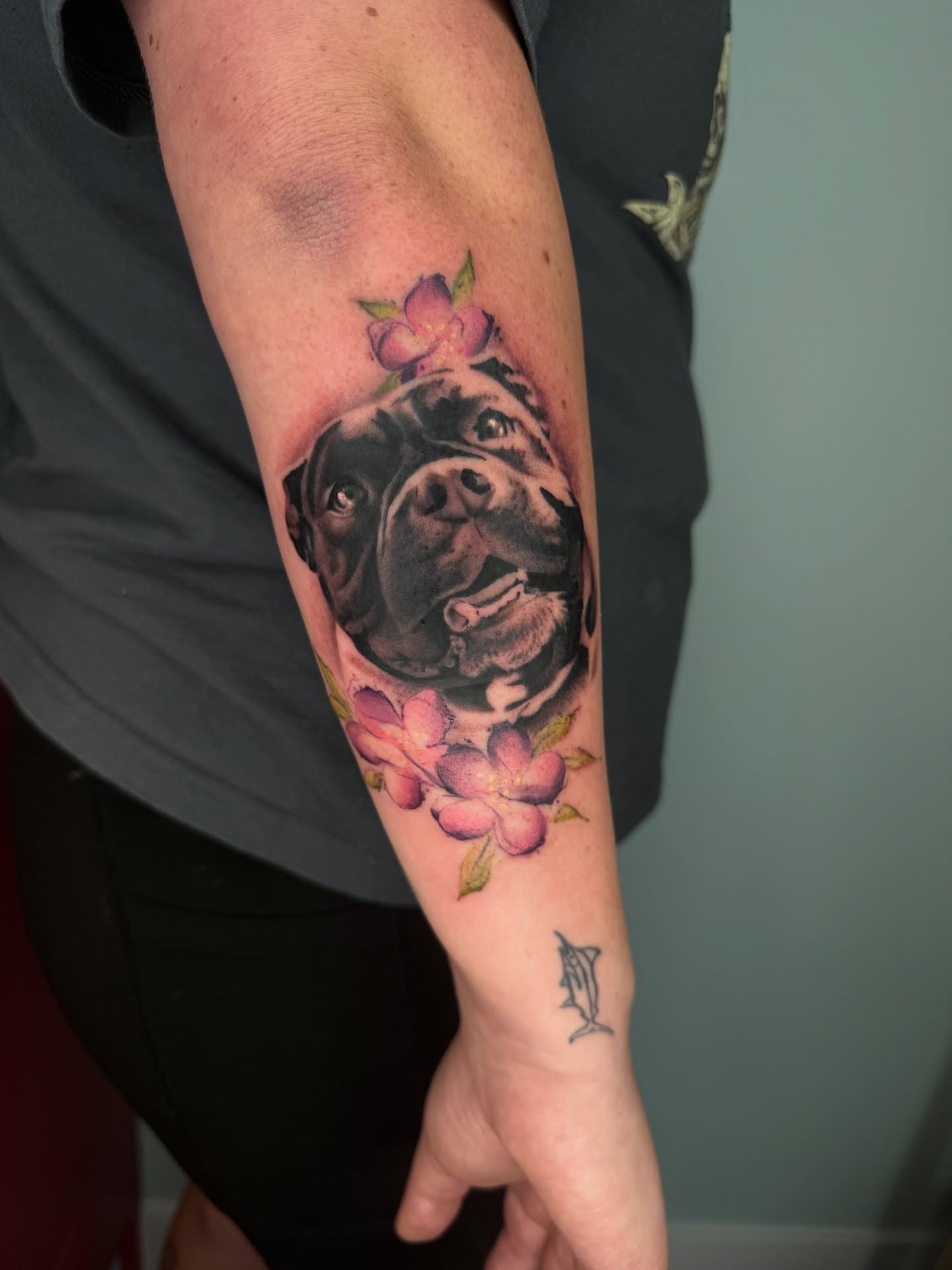 Dog with flowers realism tattoo on the forearm by Angel, Salt Lake City, Utah