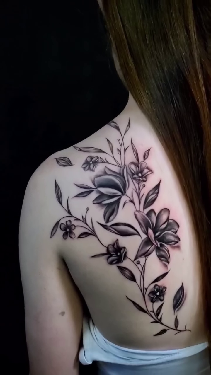Floral shoulder and upper back tattoo fine line tattoo on the shoulder by William Gualteros