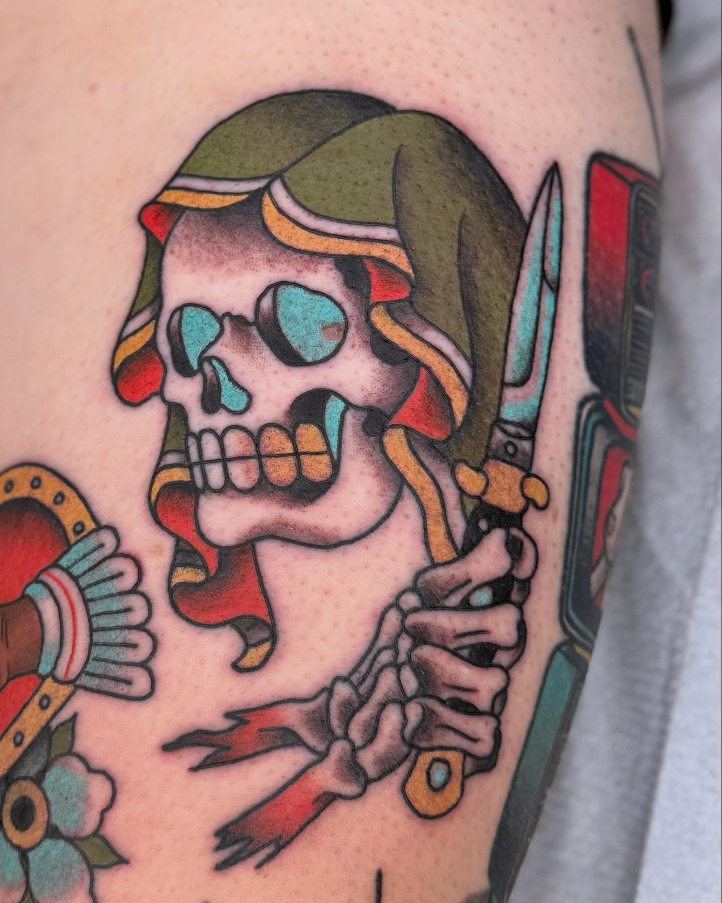 Skull with knife American traditional tattoo on the forearm by Curtis Stairs, Seattle, Washington