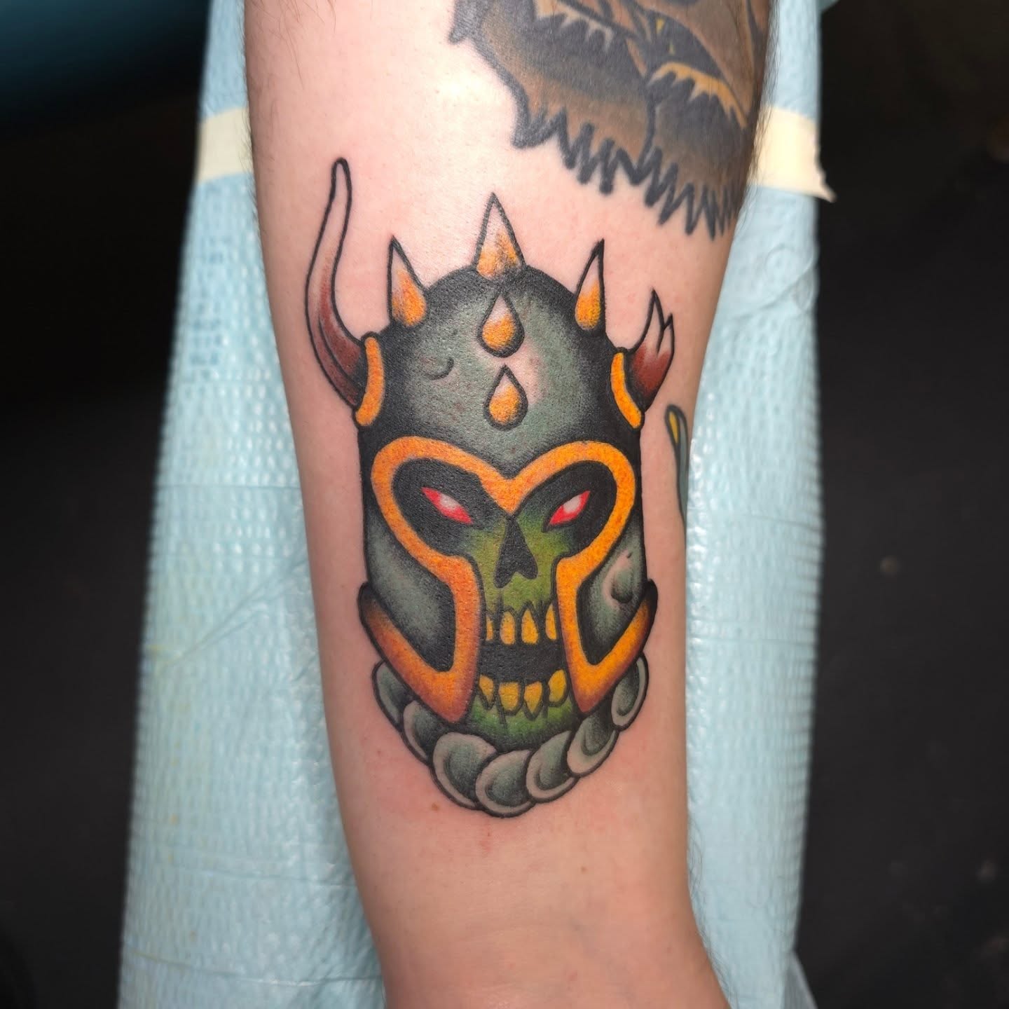 Skull with horns neo-traditional tattoo on the forearm by Jared Green