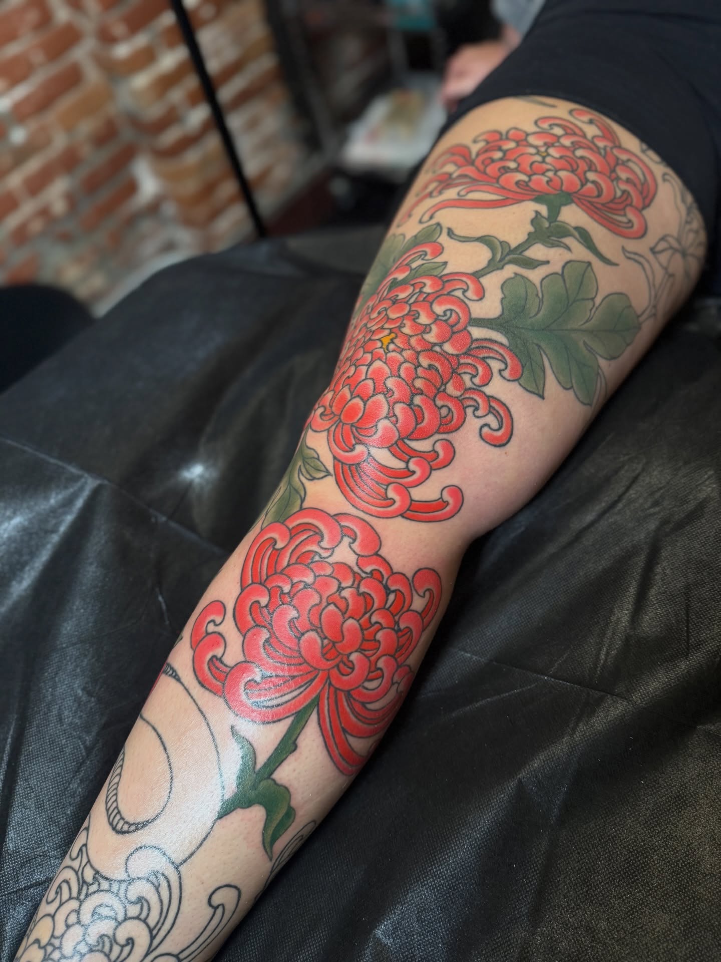 Chrysanthemums japanese irezumi tattoo on the forearm by Candi Kinyōbi