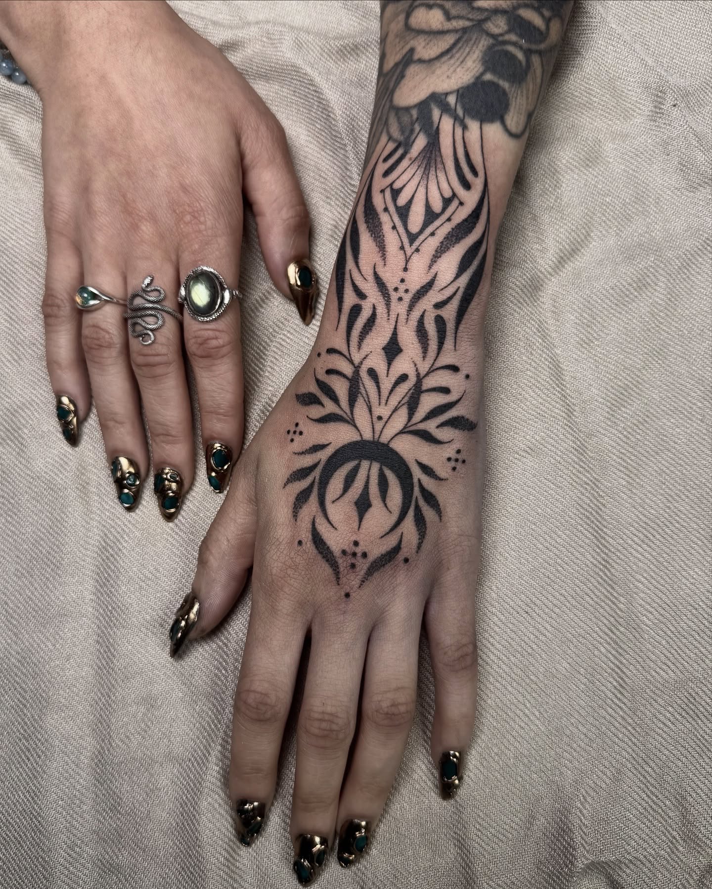 Floral design black and grey tattoo on the hand by Rose Ulinski