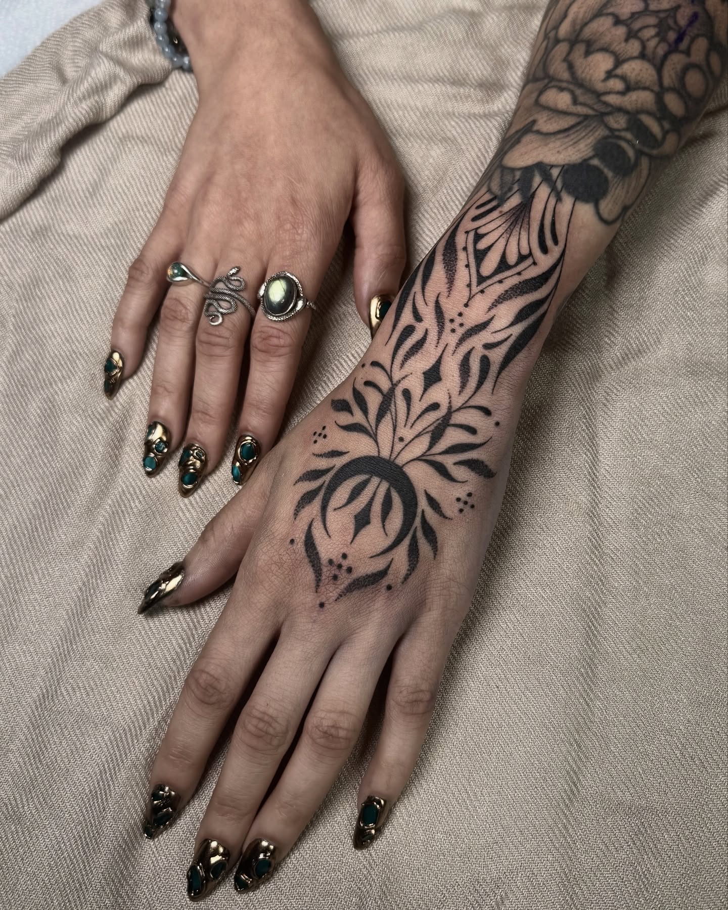 Floral design black and grey tattoo on the hand by Rose Ulinski