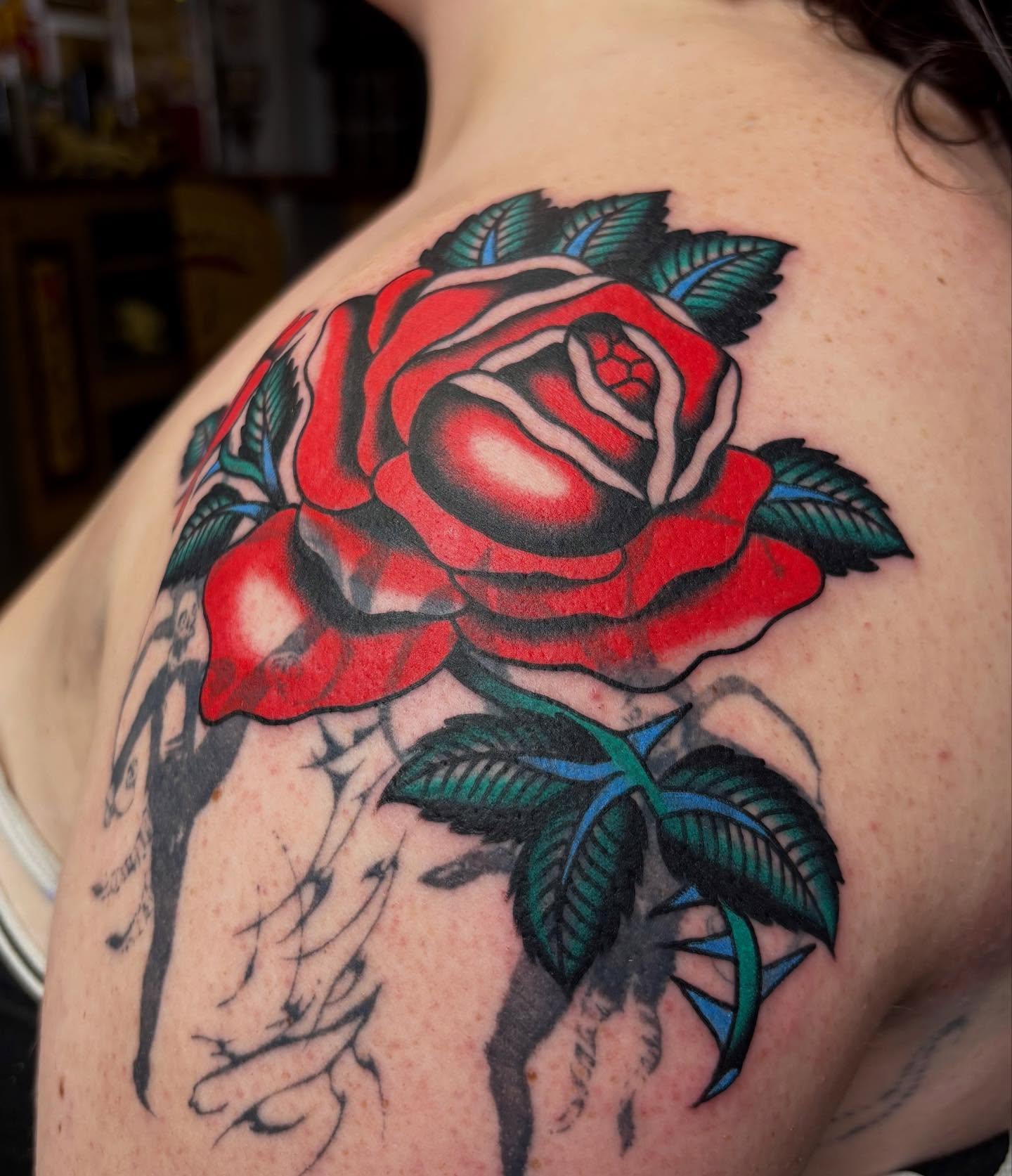 Red rose American traditional tattoo on the shoulder by Izzy