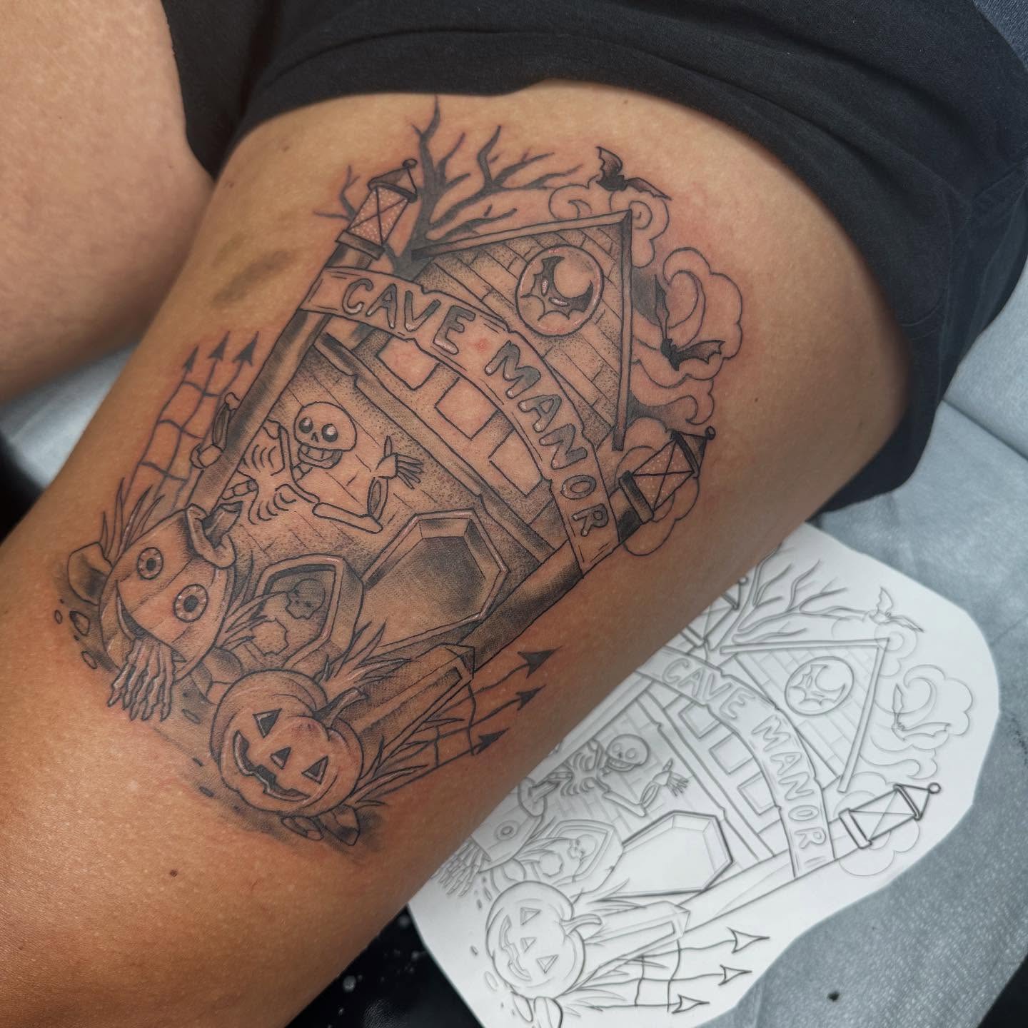 Haunted house black and grey tattoo on the thigh by Halle Haas
