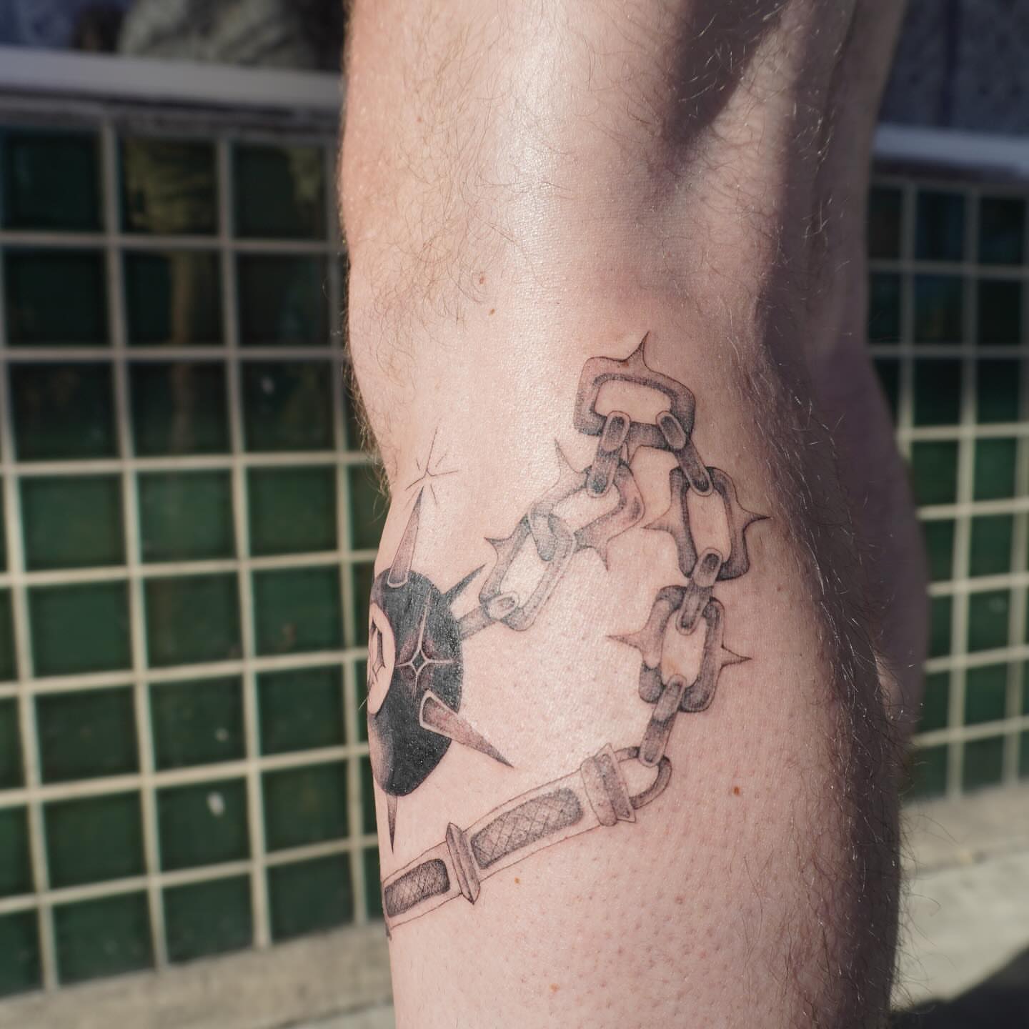 Chains and dagger black and grey tattoo on the forearm by San Diego tattoo artist