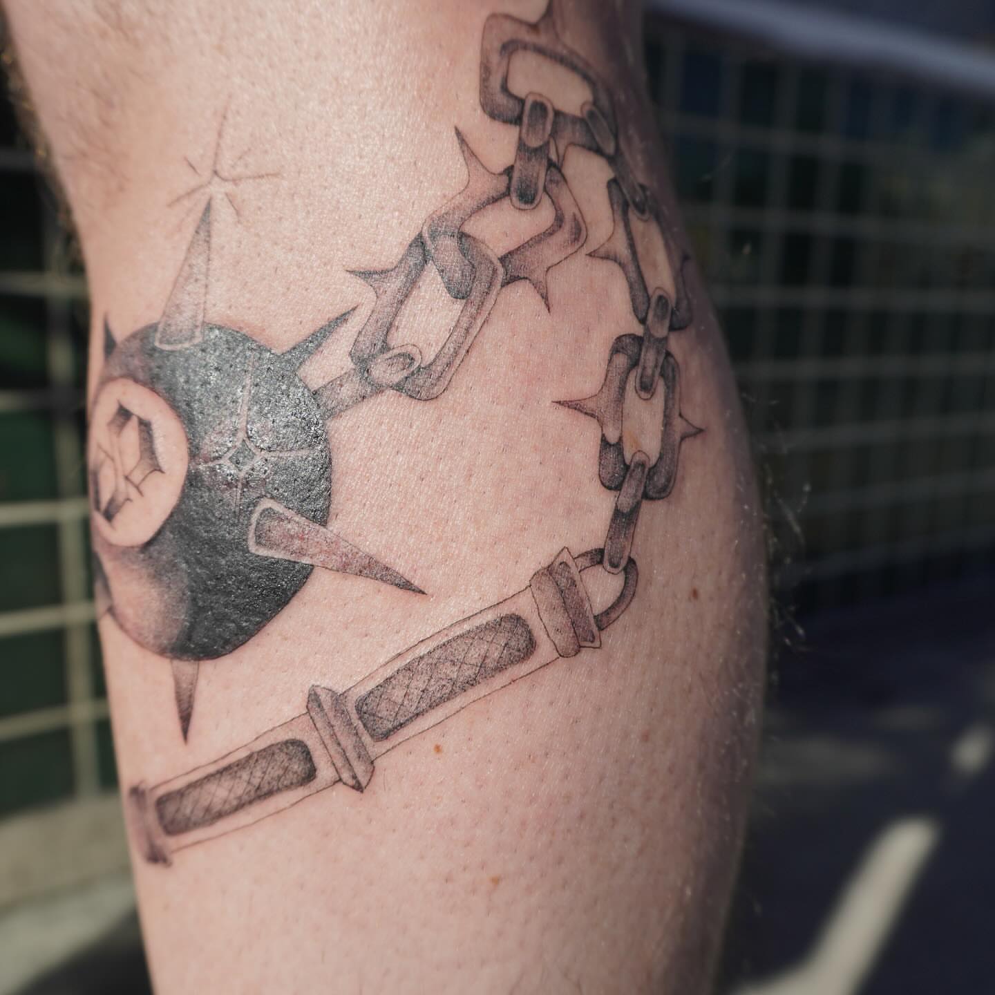 Ball and chain black and grey tattoo on the forearm by San Diego tattoo artist