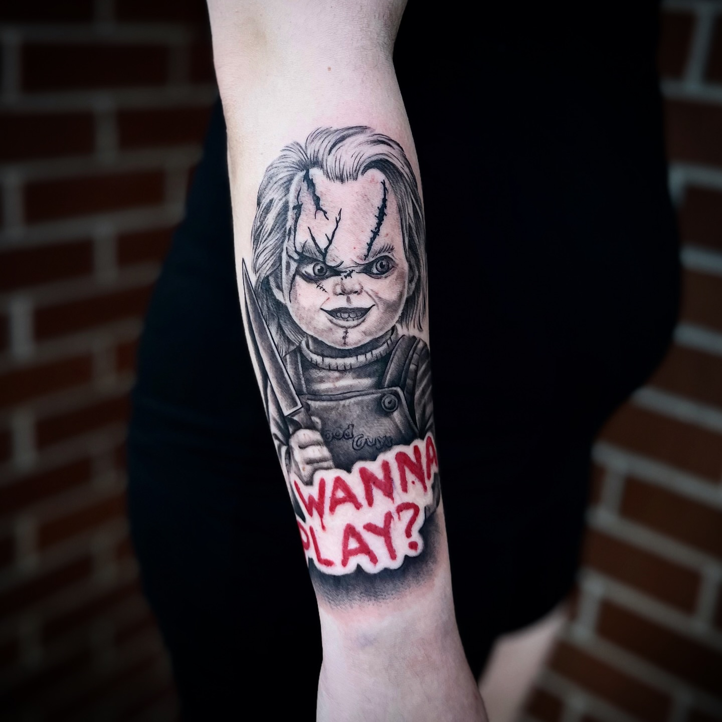 Chucky doll realism tattoo on the forearm by Lauren Dempsey, Dearborn, Michigan