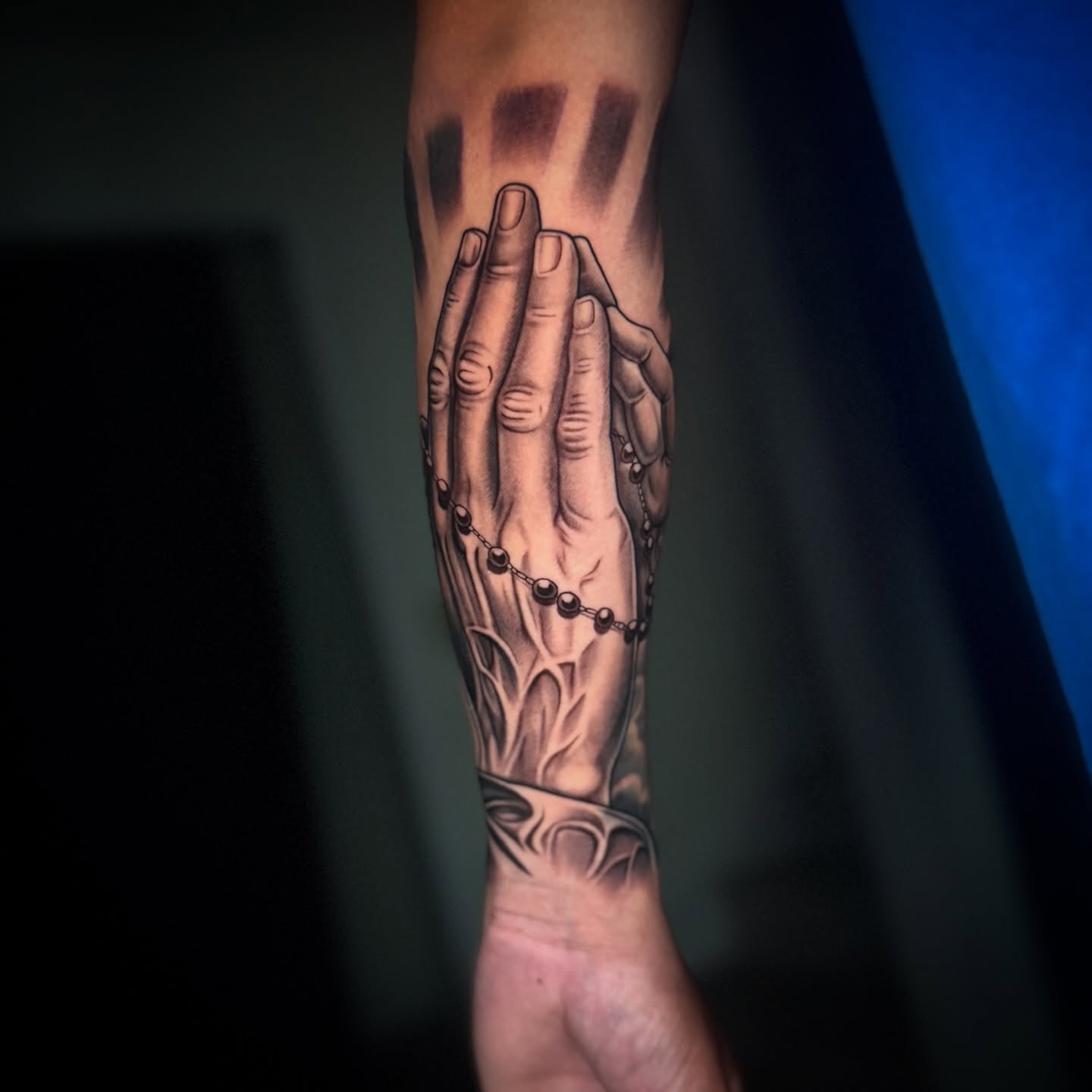 Praying hands realism tattoo on the forearm by Geo