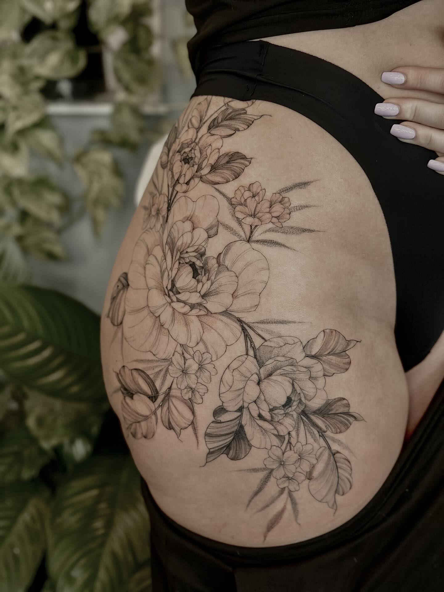 Floral arrangement black and grey tattoo on the thigh by 🌙nadia Renee