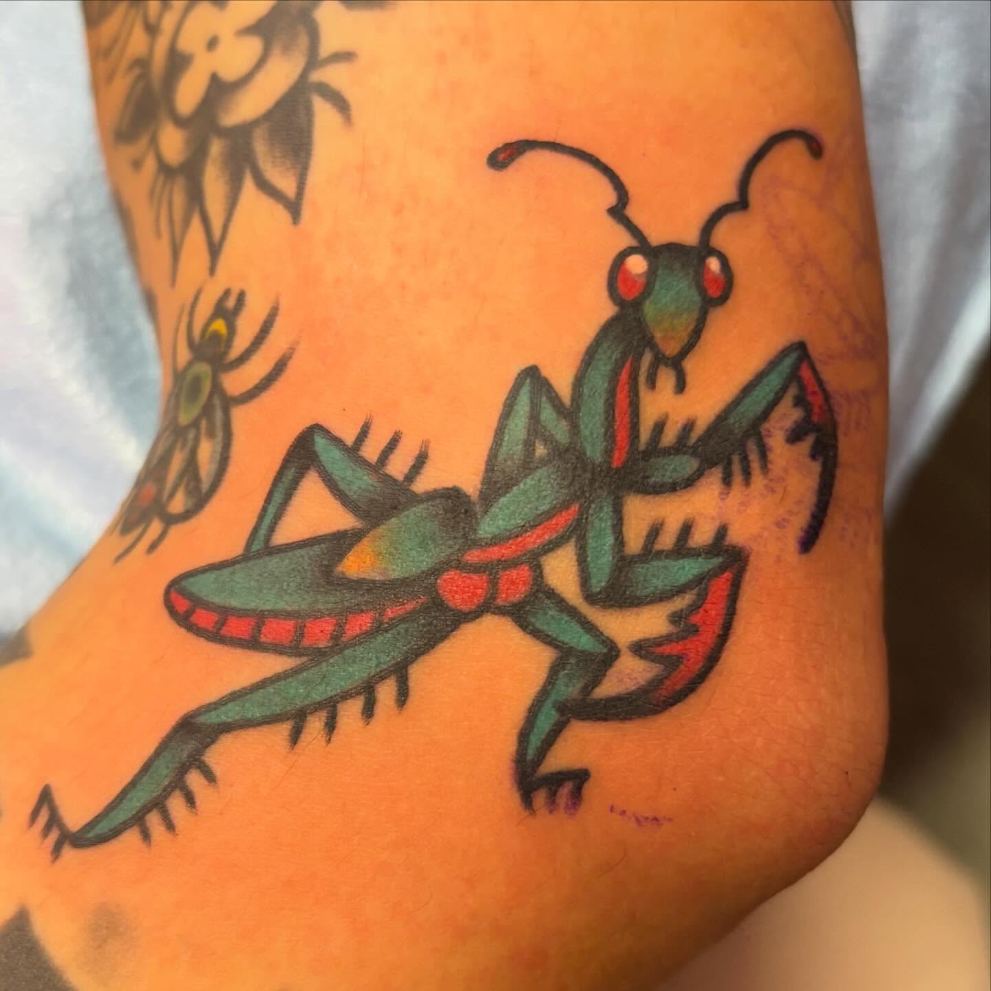 Praying mantis American traditional tattoo on the forearm by @dannydoestattoos