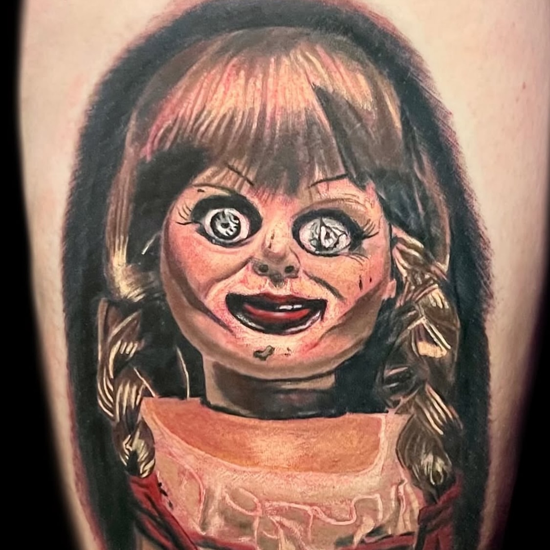 Annabelle doll realism tattoo on the forearm by Nicholas Misitano