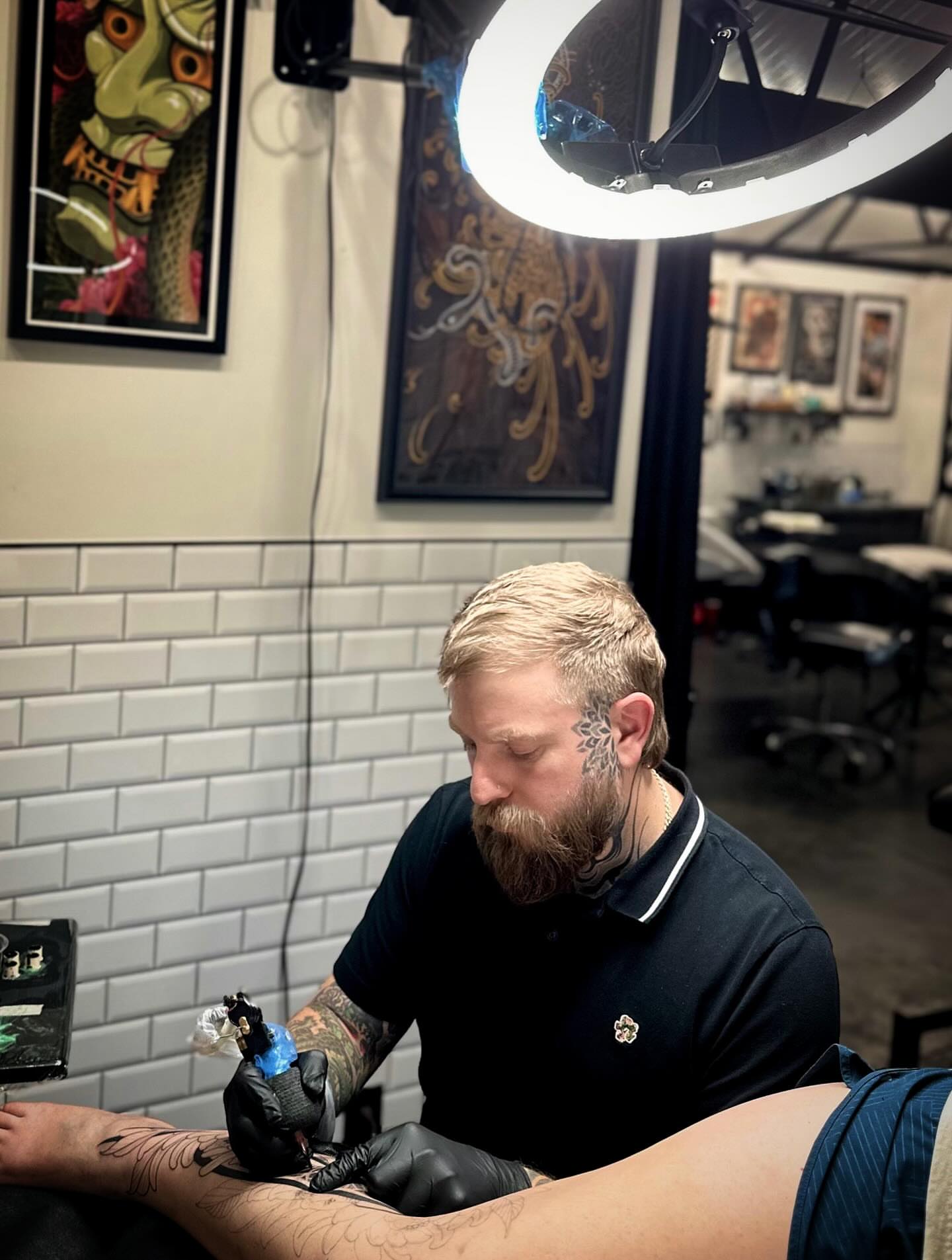 Bearded man American traditional tattoo on the upper arm by Kevin Johnson