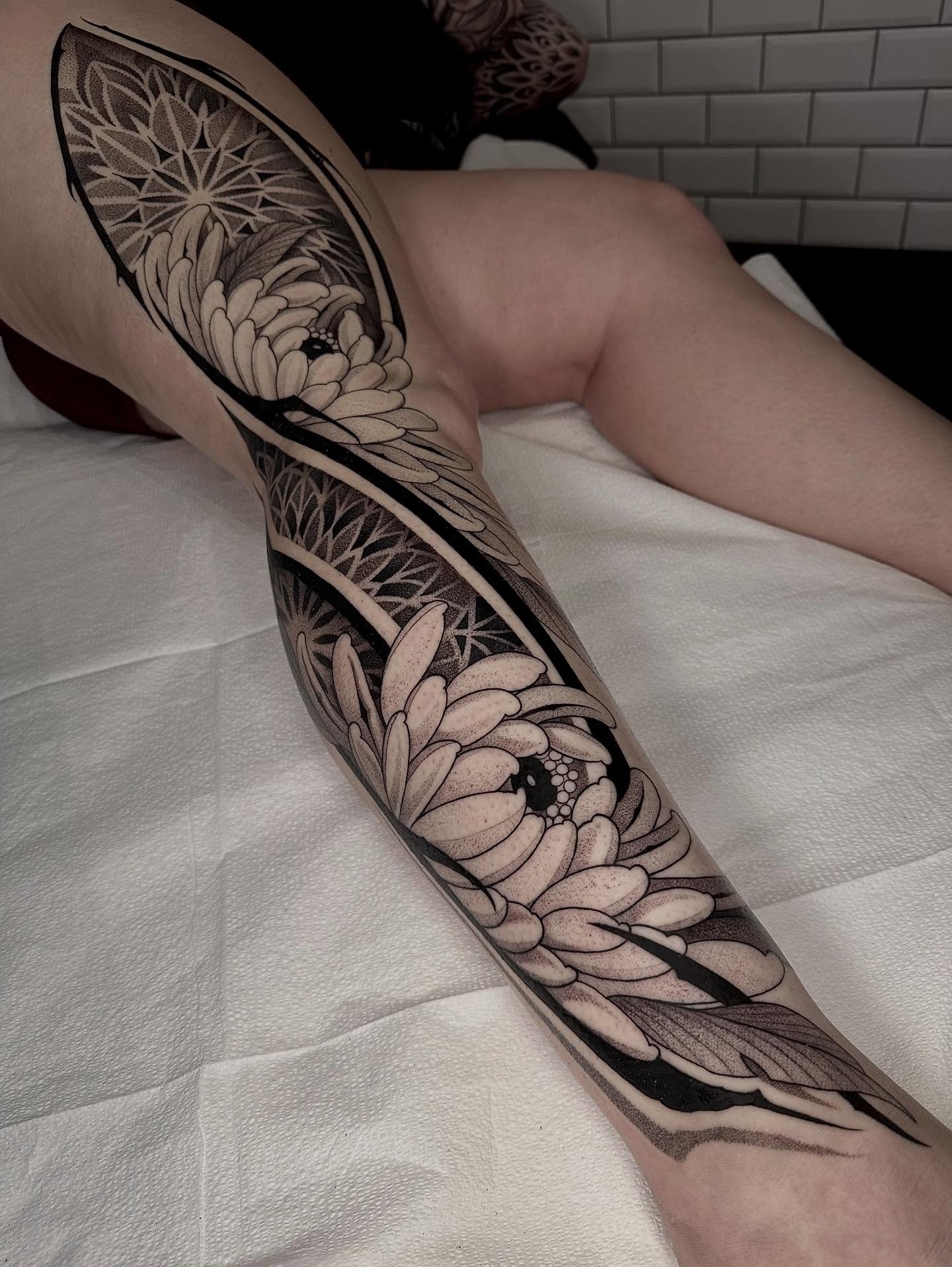 Chrysanthemums black and grey tattoo on the forearm by Kevin Johnson