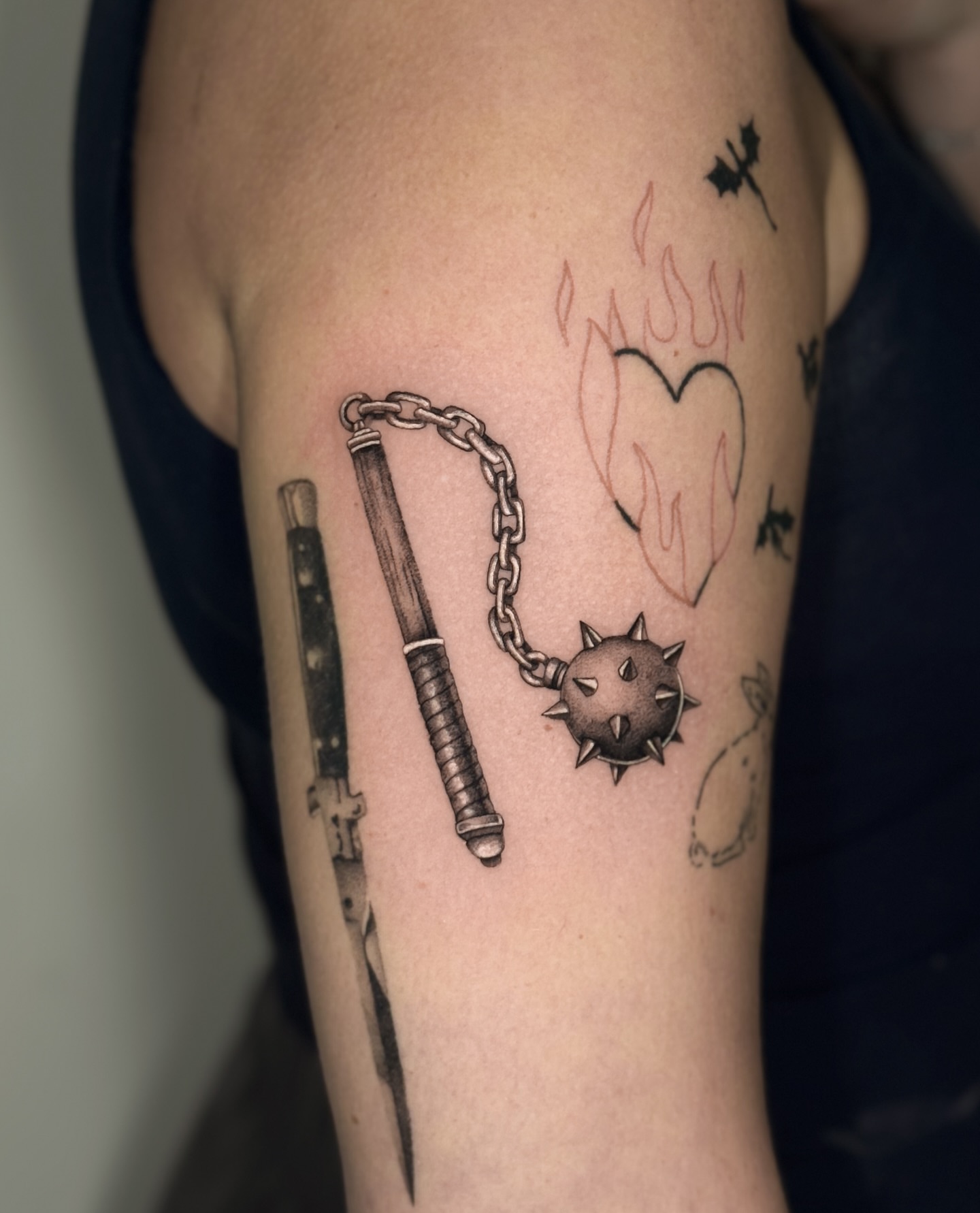 Nunchaku and spiked ball black and grey tattoo on the forearm by Miami Tattoo Artist, Miami, Florida