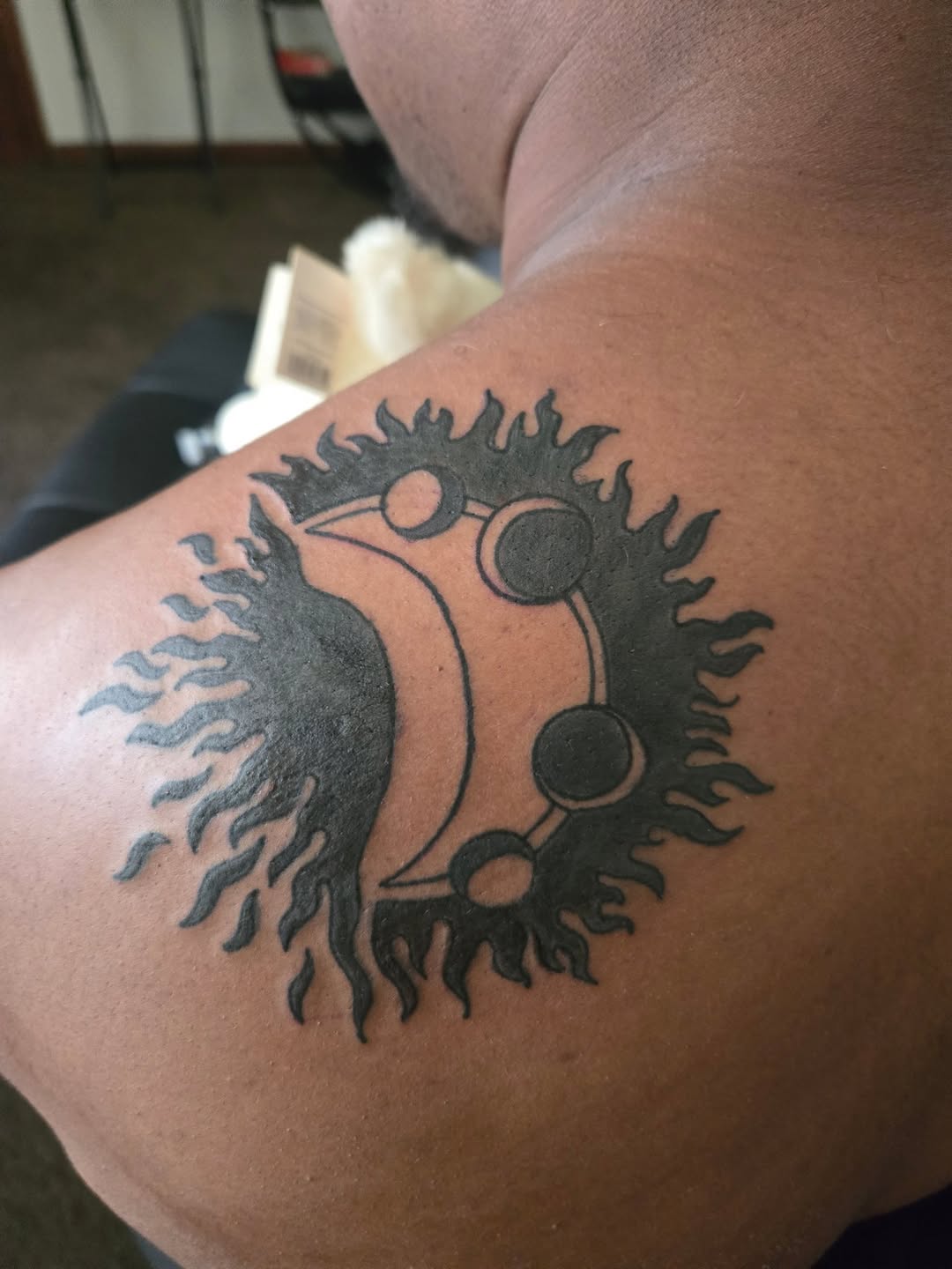 Sun and moon symbol tattoo on the shoulder by Trent Johnson
