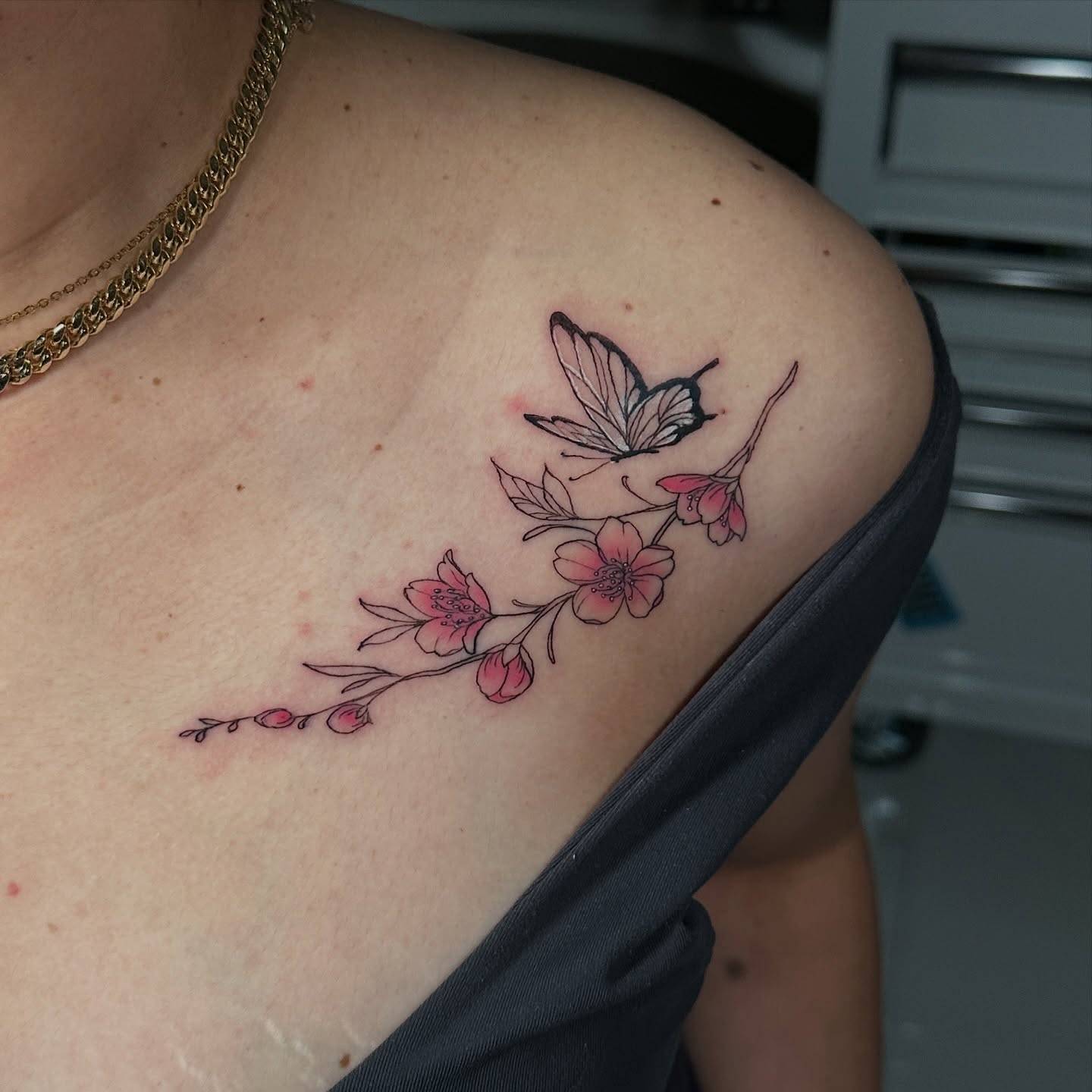 Cherry blossoms and butterfly dotwork tattoo on the shoulder by Dennis Alejandro