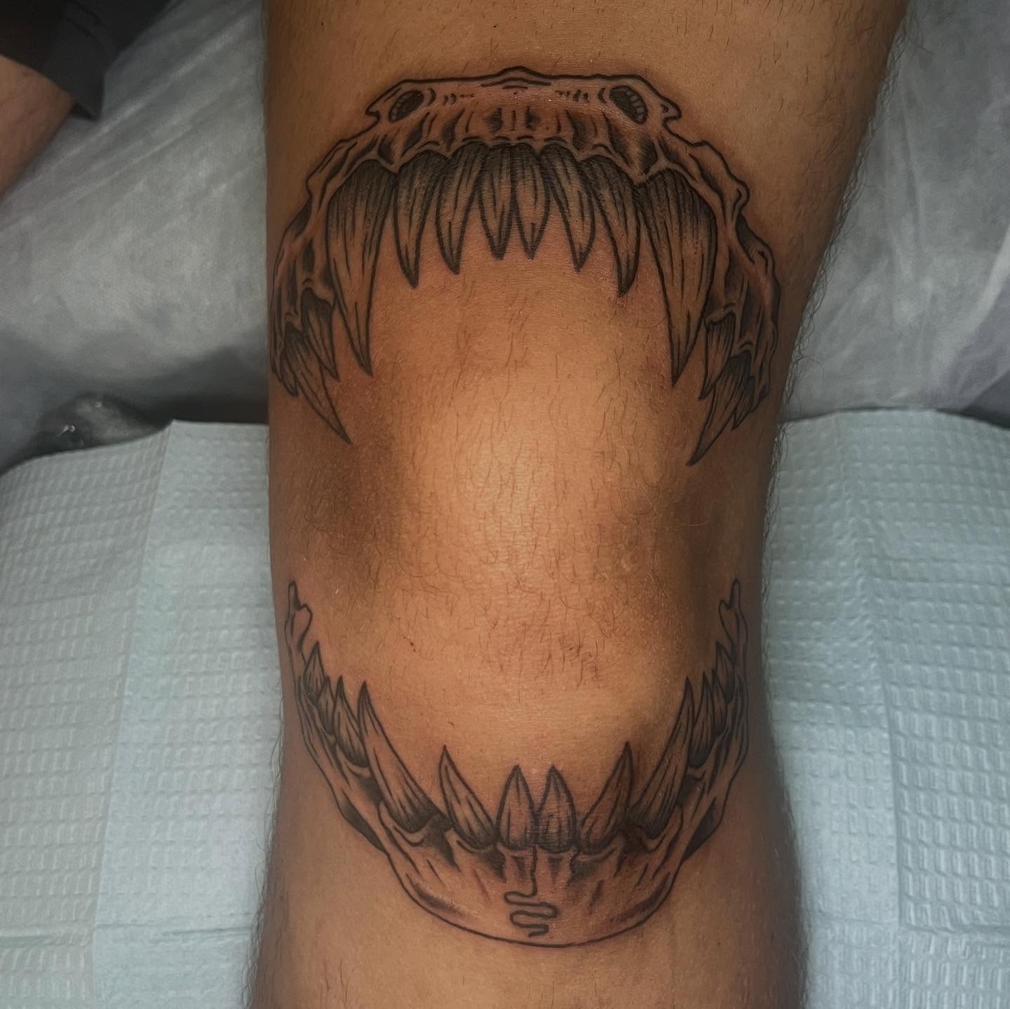 Jaws black and grey tattoo on the leg by Ryan Kim