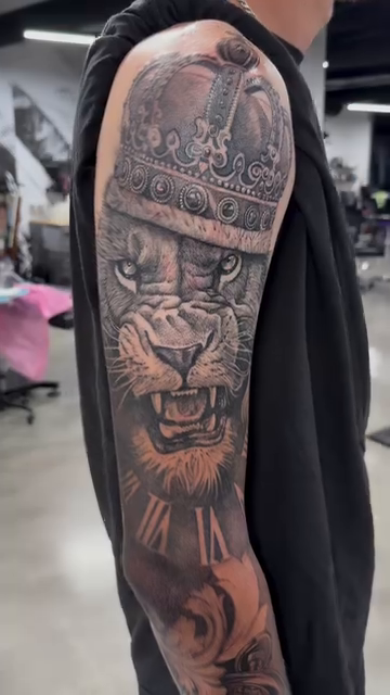 Lion with crown and compass realism tattoo by Absolute