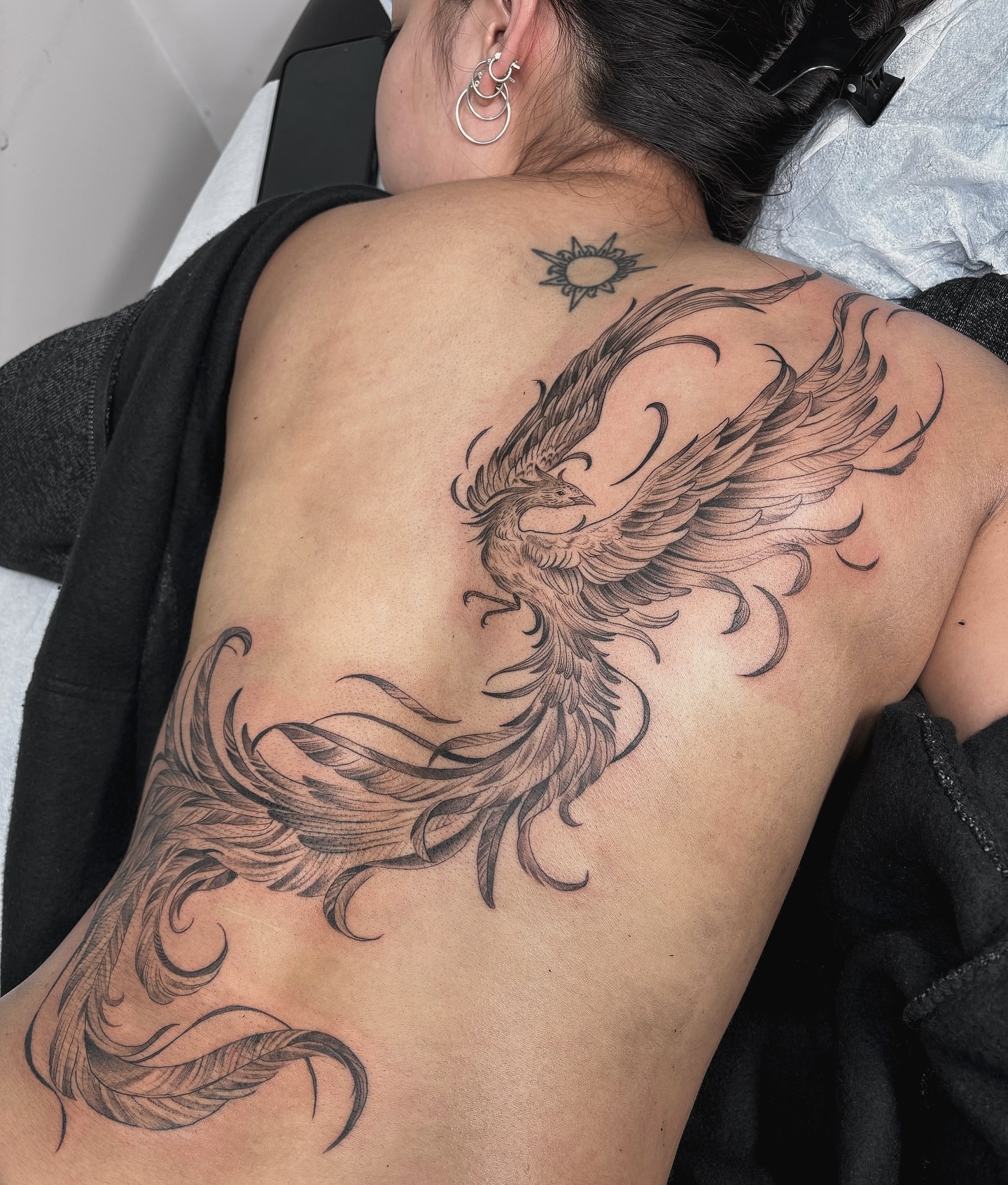 Phoenix black and grey tattoo on the back by Kinsey Miller