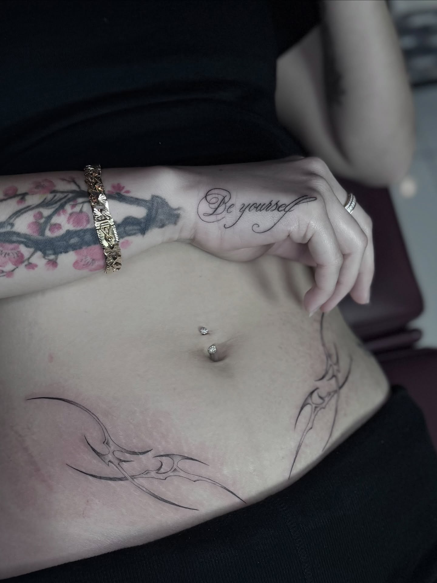 Cherry blossoms American traditional tattoo on the torso by B o n d B o n d , “ a r t i s t “