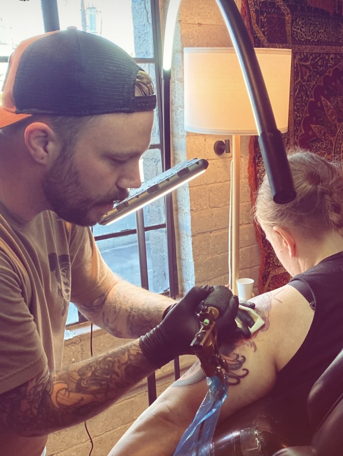 Floral design American traditional tattoo on the upper arm by Aaron Wallace