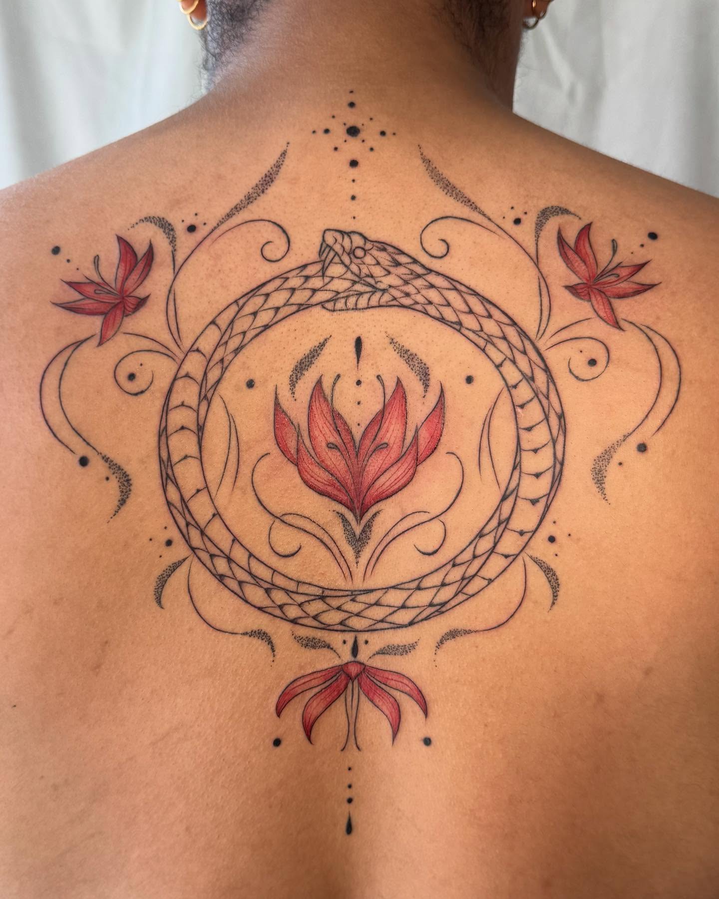 Snake and lotus dotwork tattoo on the back by RyAnn Lynn