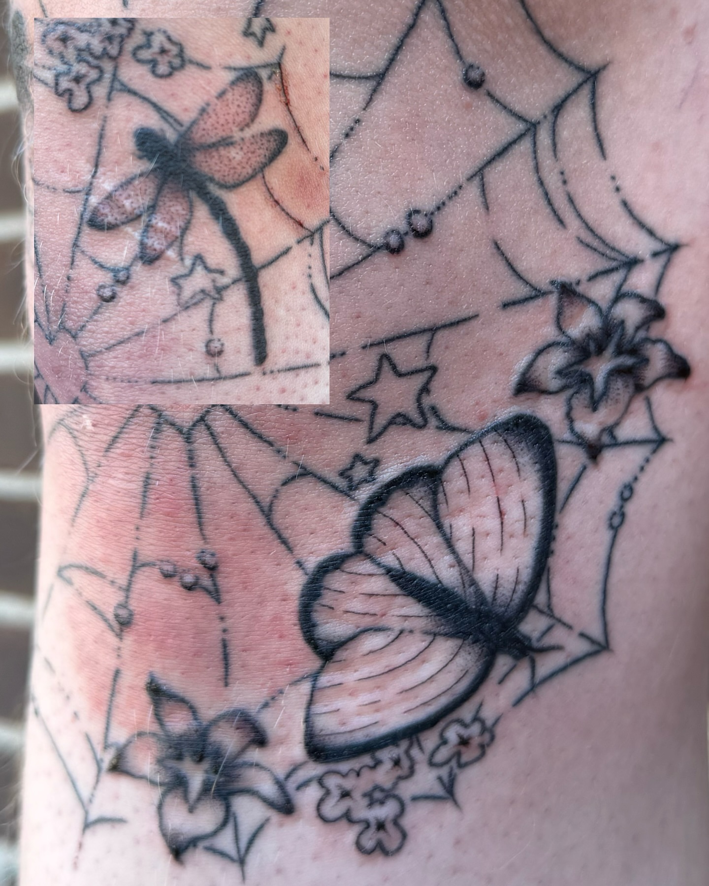 Butterfly and flowers black and grey tattoo on the forearm by Milo