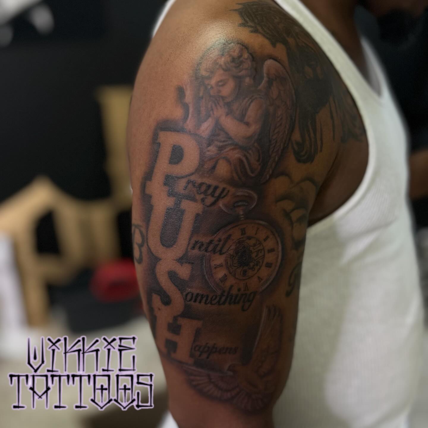 Praying angel with pocket watch realism tattoo on the upper arm by Victoria Mendez