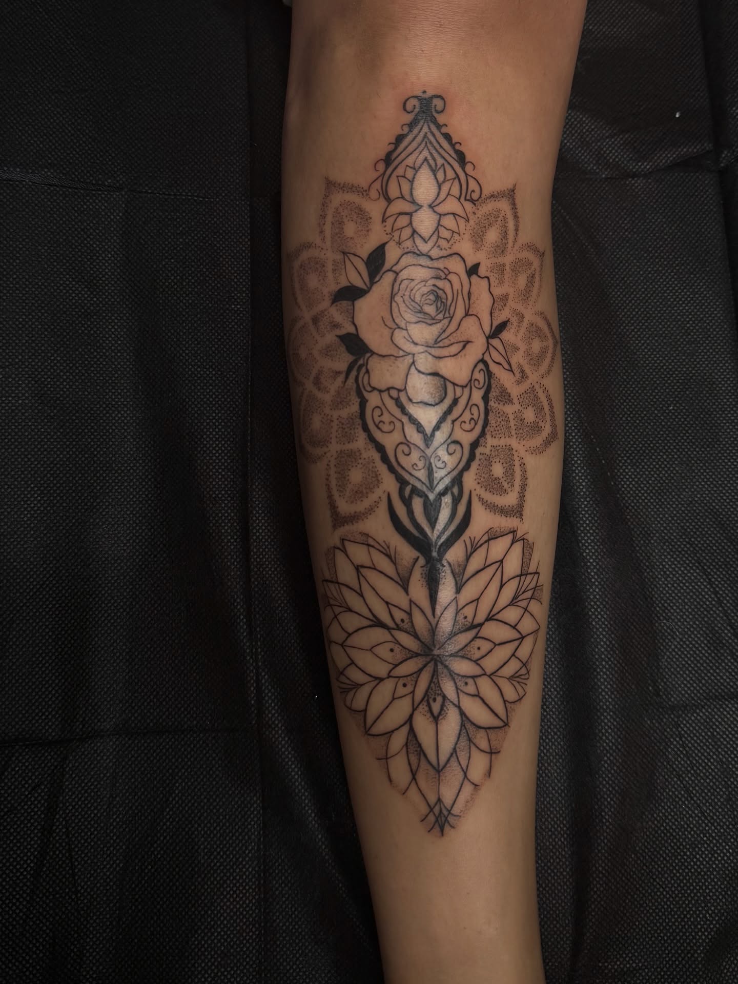 Lotus and roses dotwork tattoo on the forearm by ᴍᴀɢɢɪᴇ ✧, Las Vegas, Nevada