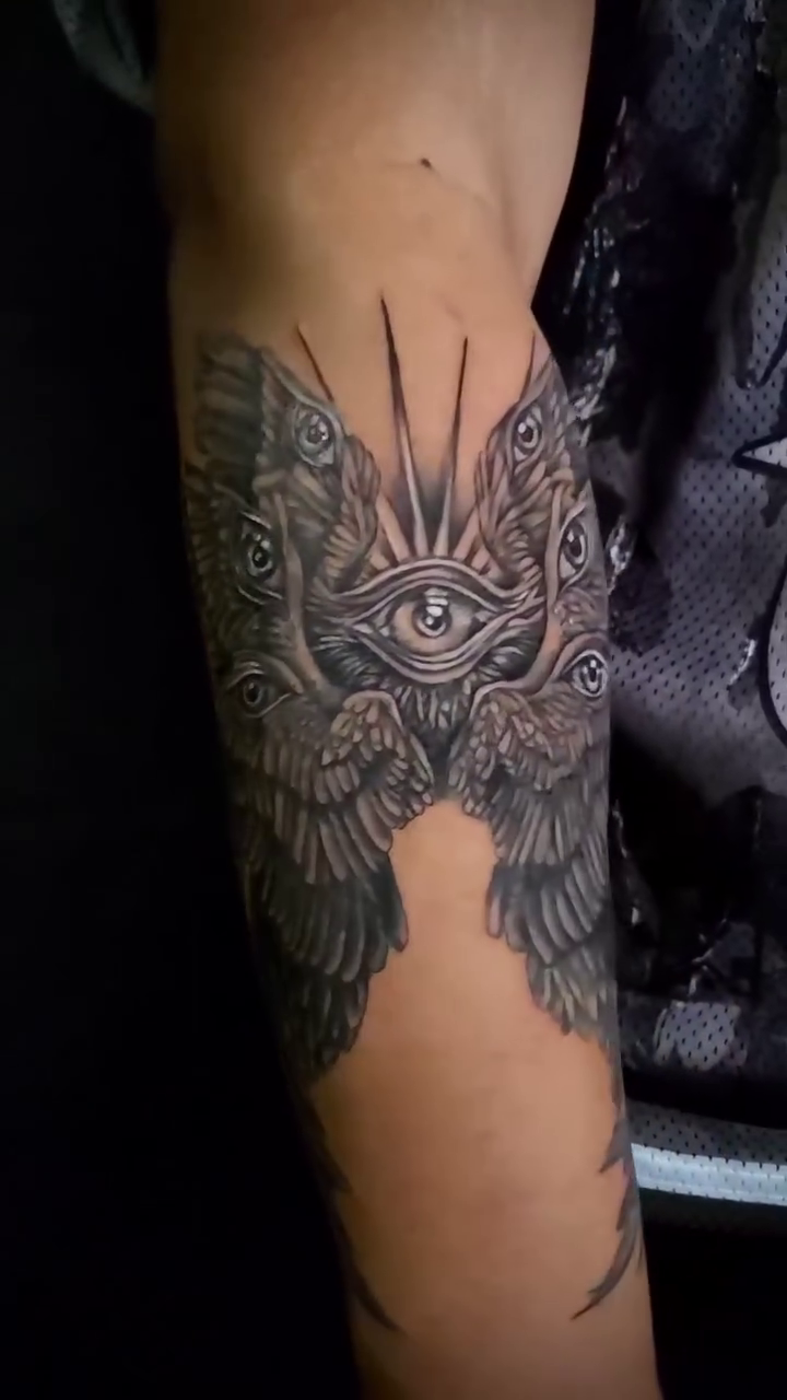 Multi-eyed winged creature realism tattoo on the forearm by William Gualteros