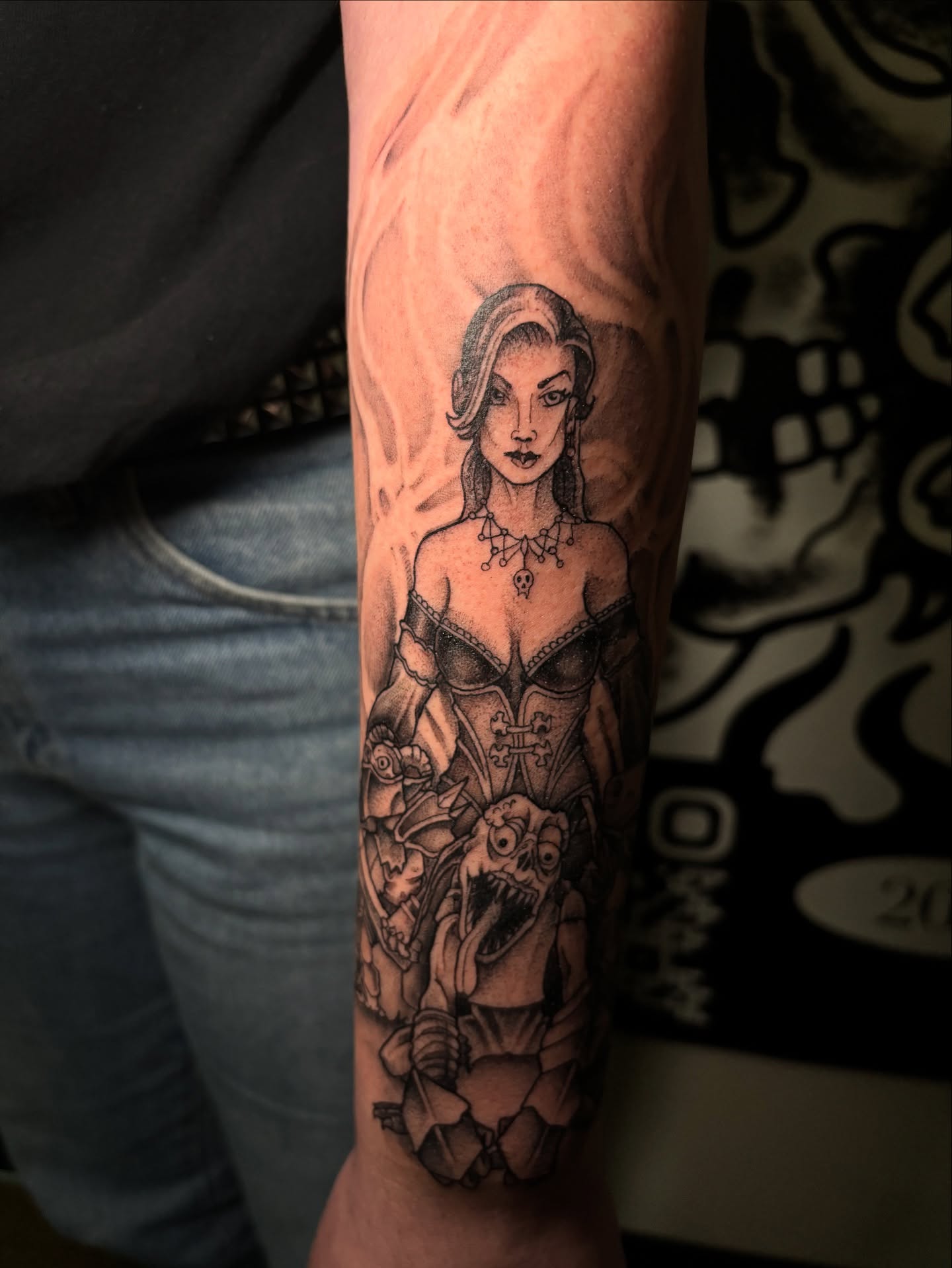 Woman with demon realism tattoo on the forearm by Ares Rhodes