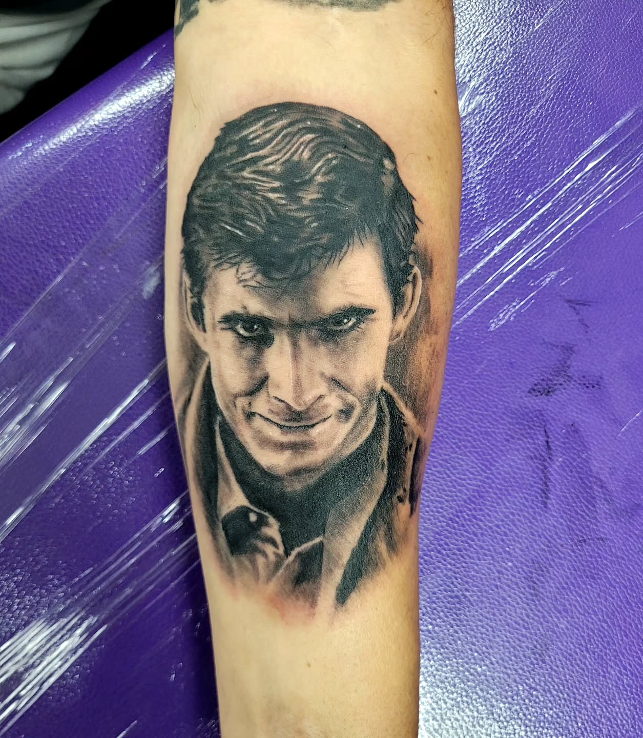 Man's face realism tattoo on the forearm by Jentrey McCausland