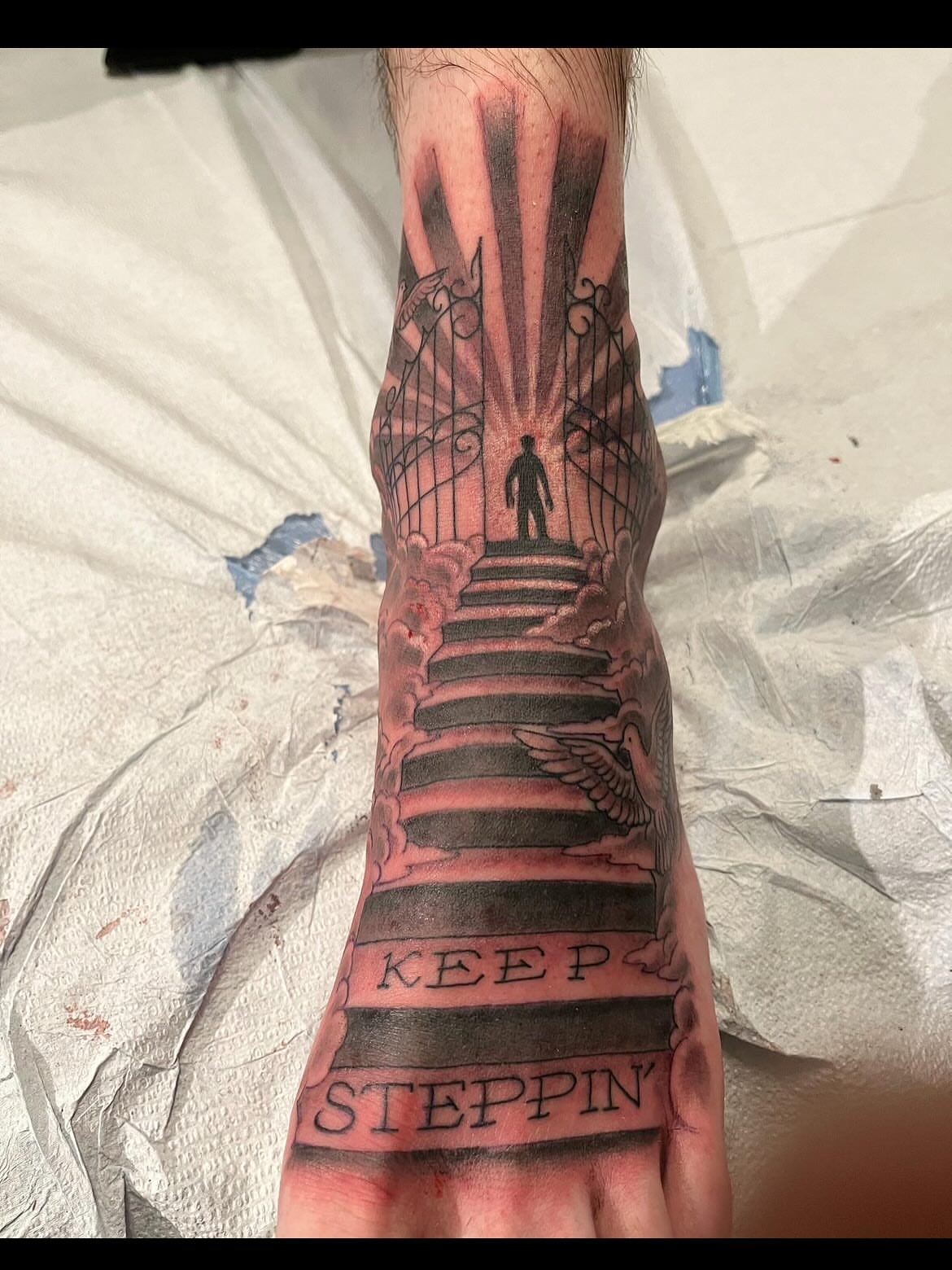 Staircase with gate black and grey tattoo on the foot by Miles Maniaci, Chicago, Illinois